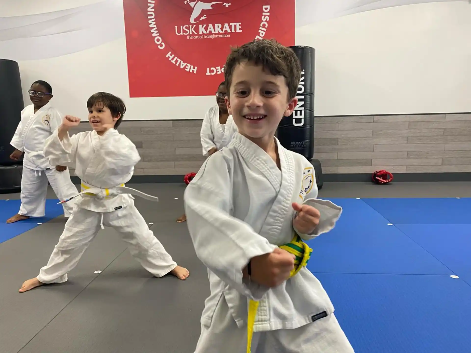 a group of kids in karate uniforms