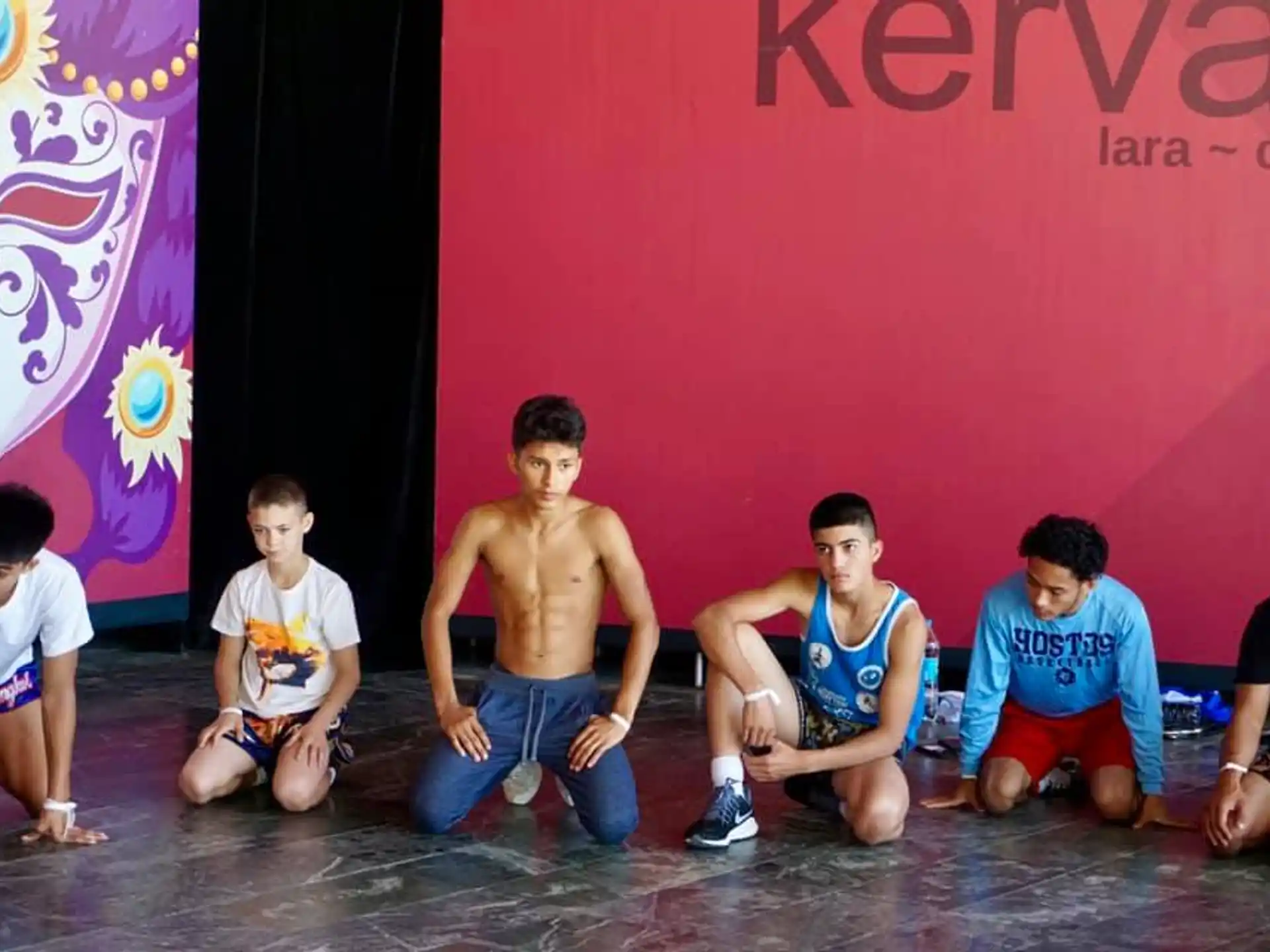 a group of boys sitting on the floor