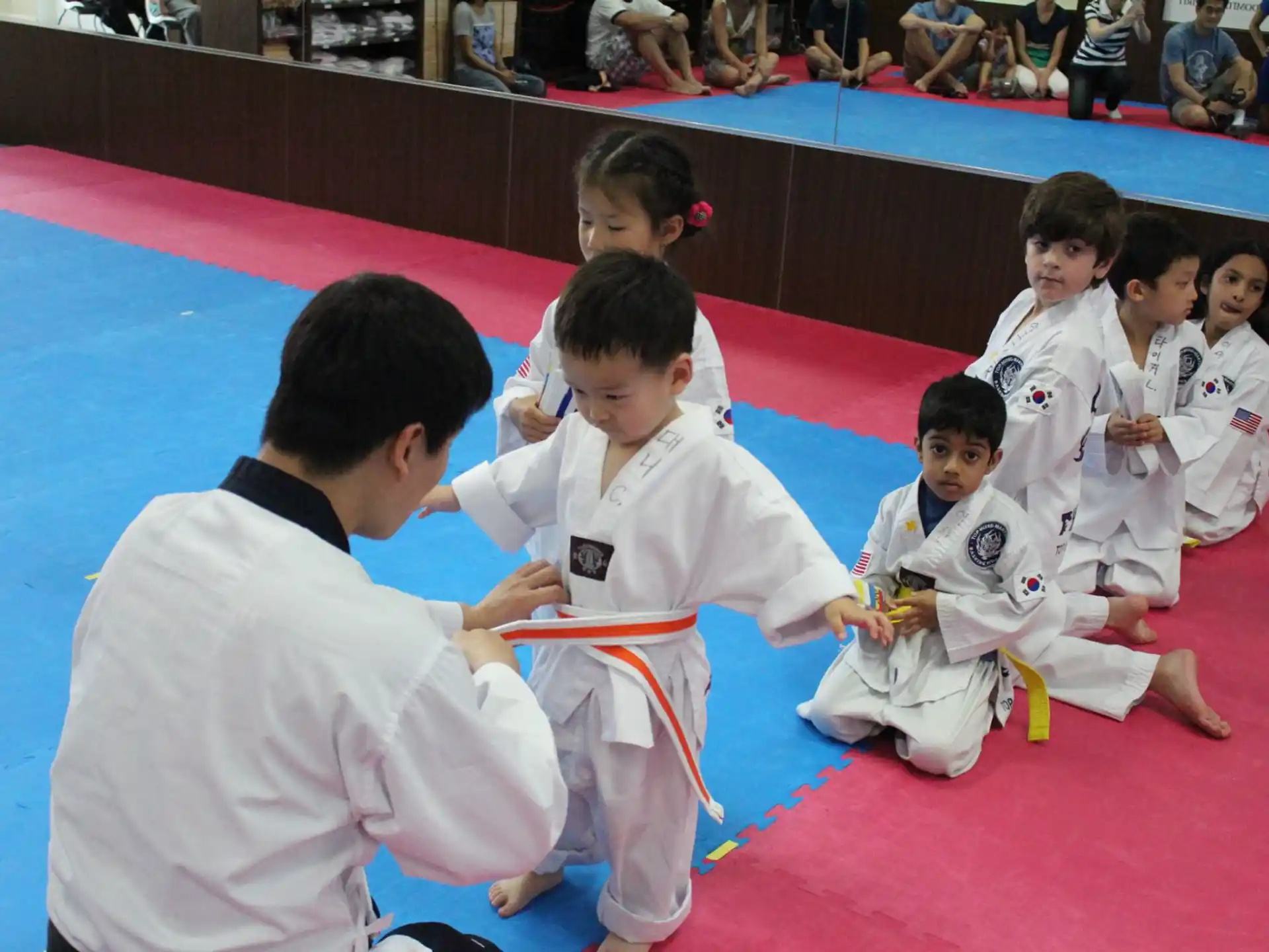 a group of children in karate uniforms