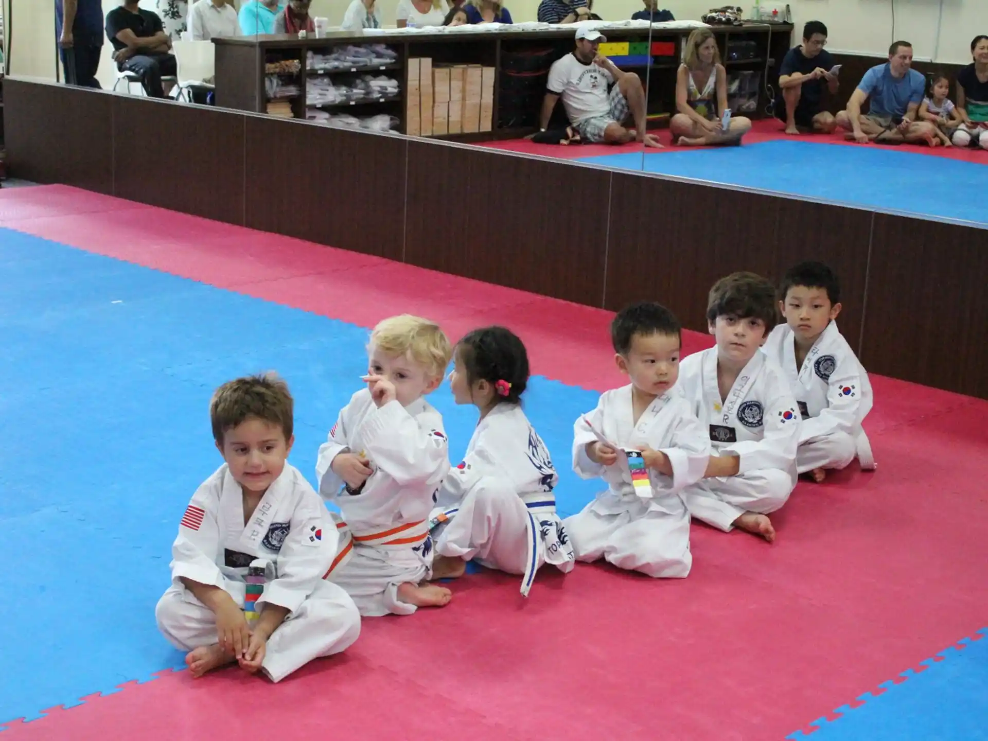 a group of kids in karate uniforms