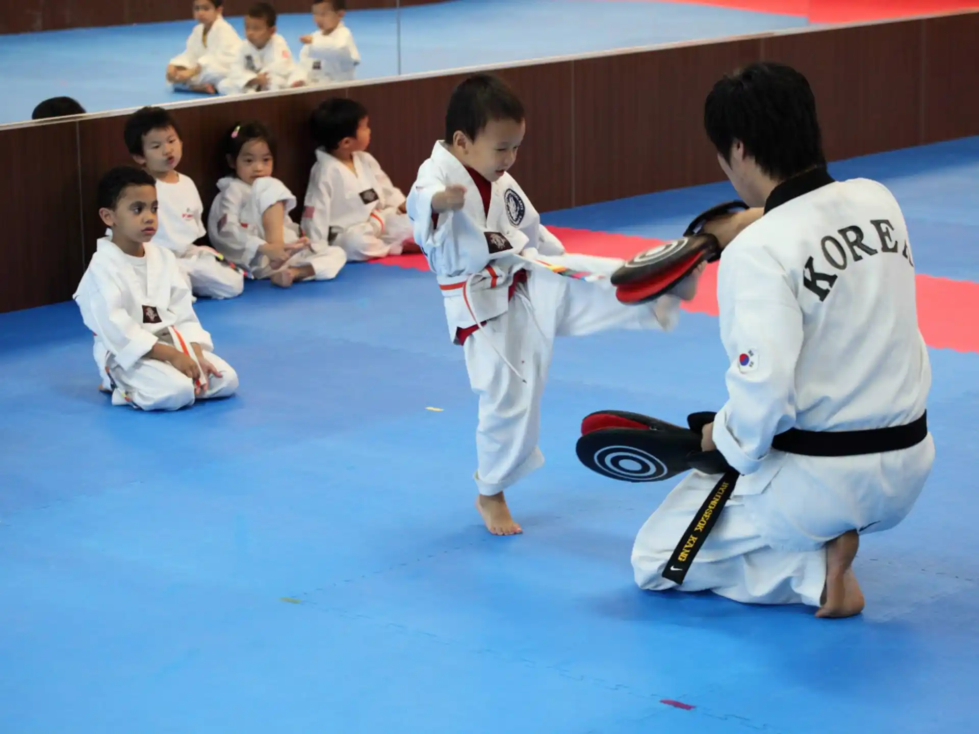 a group of kids in karate uniforms