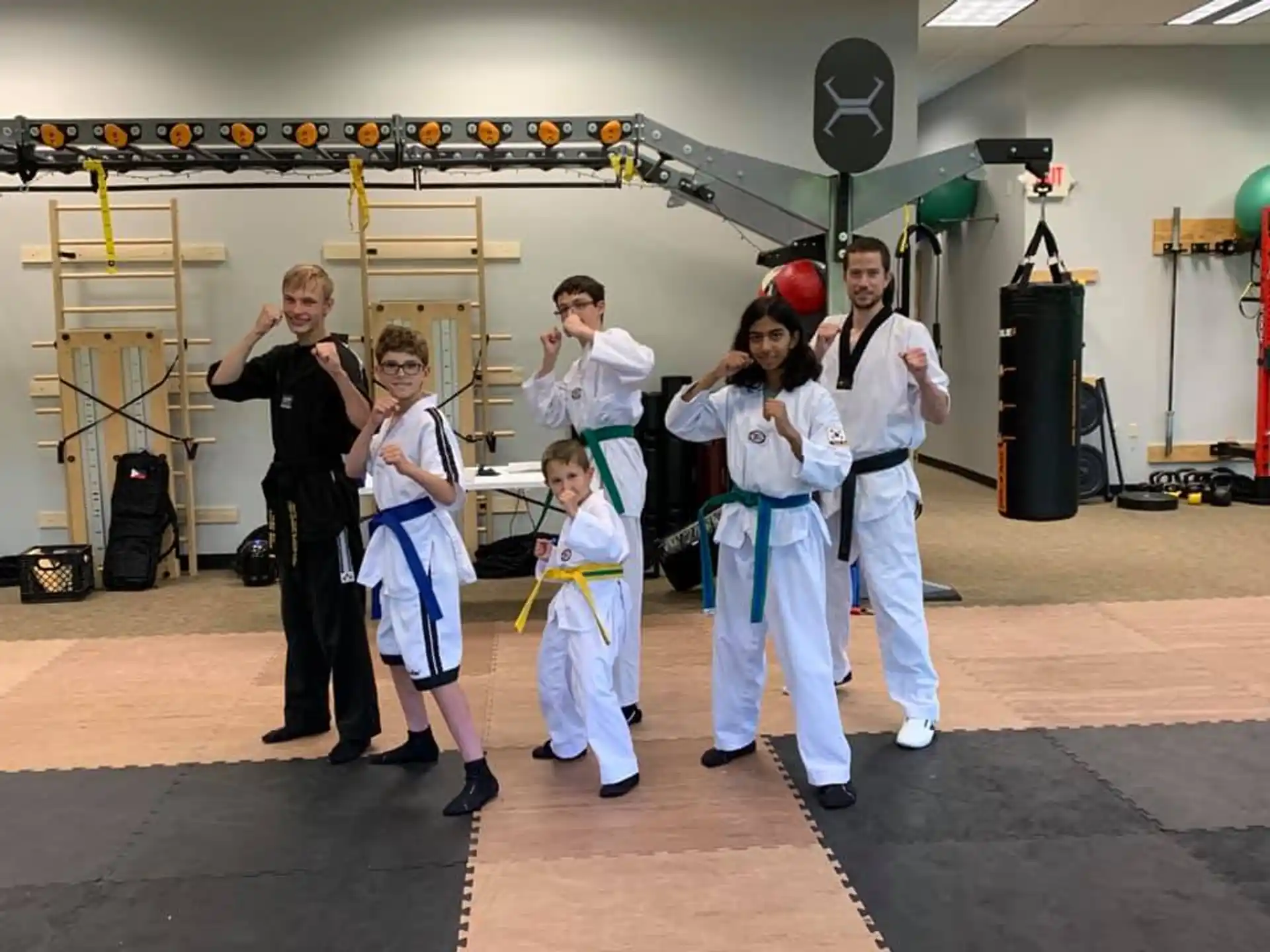 a group of people in white karate uniforms