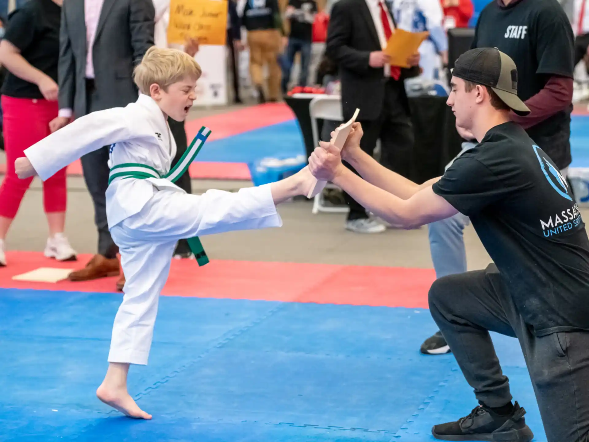 a person and a boy practicing karate