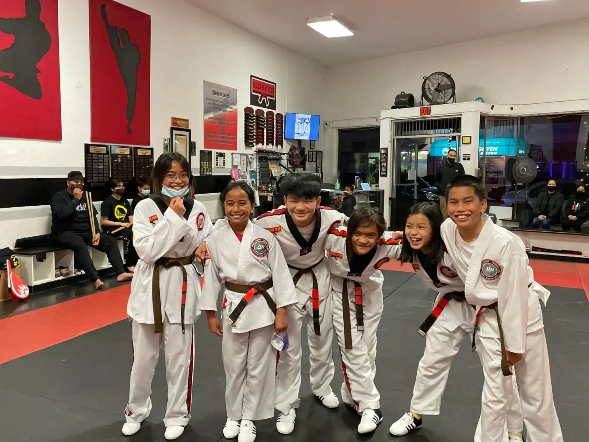 a group of people in white karate uniforms