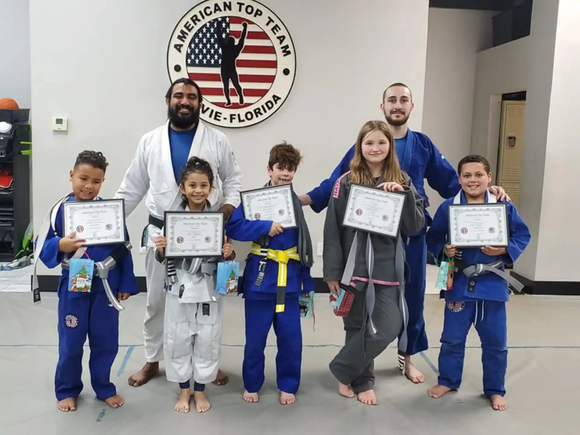 a group of people holding certificates