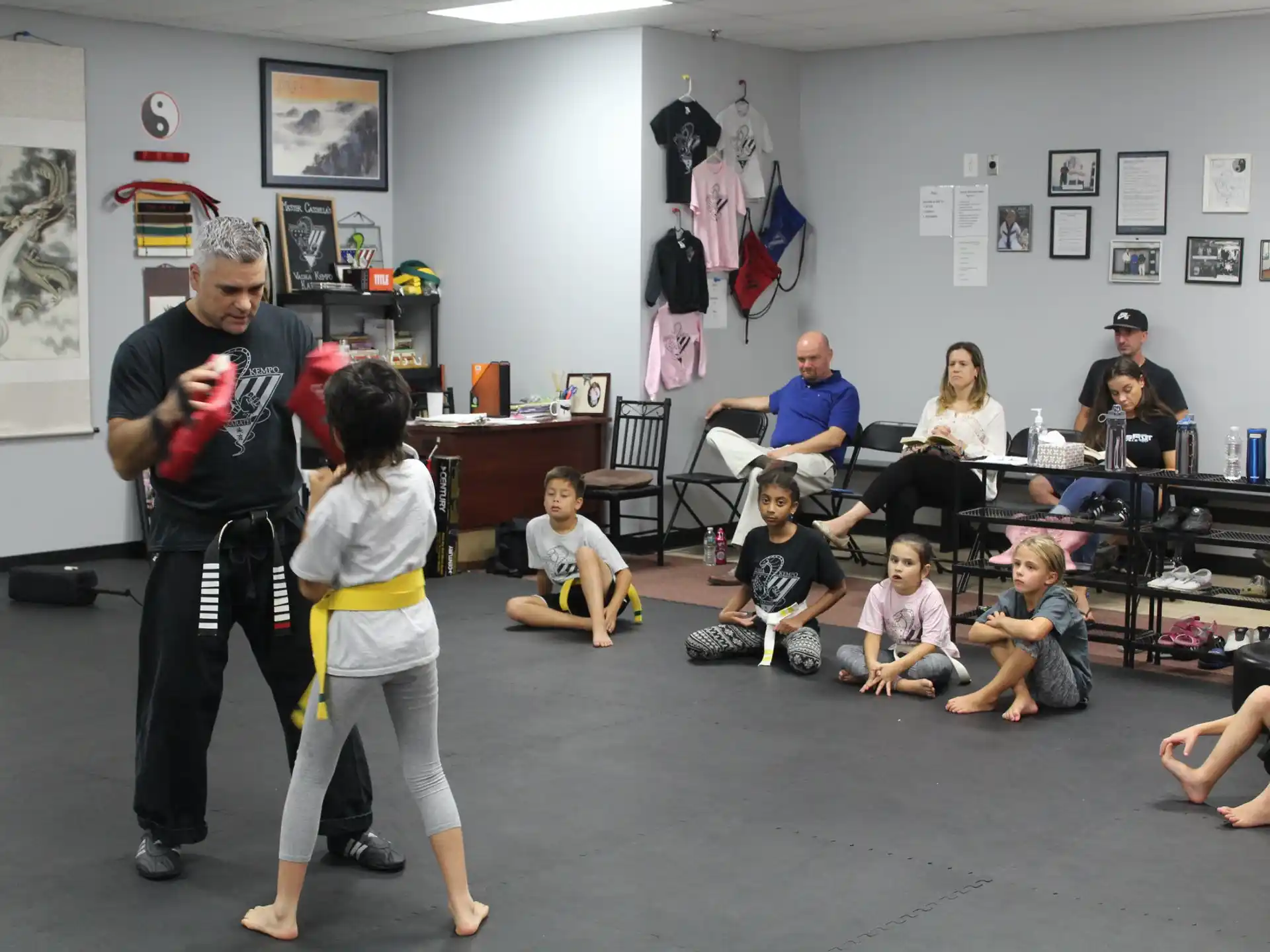 a man and a woman dancing with a group of children
