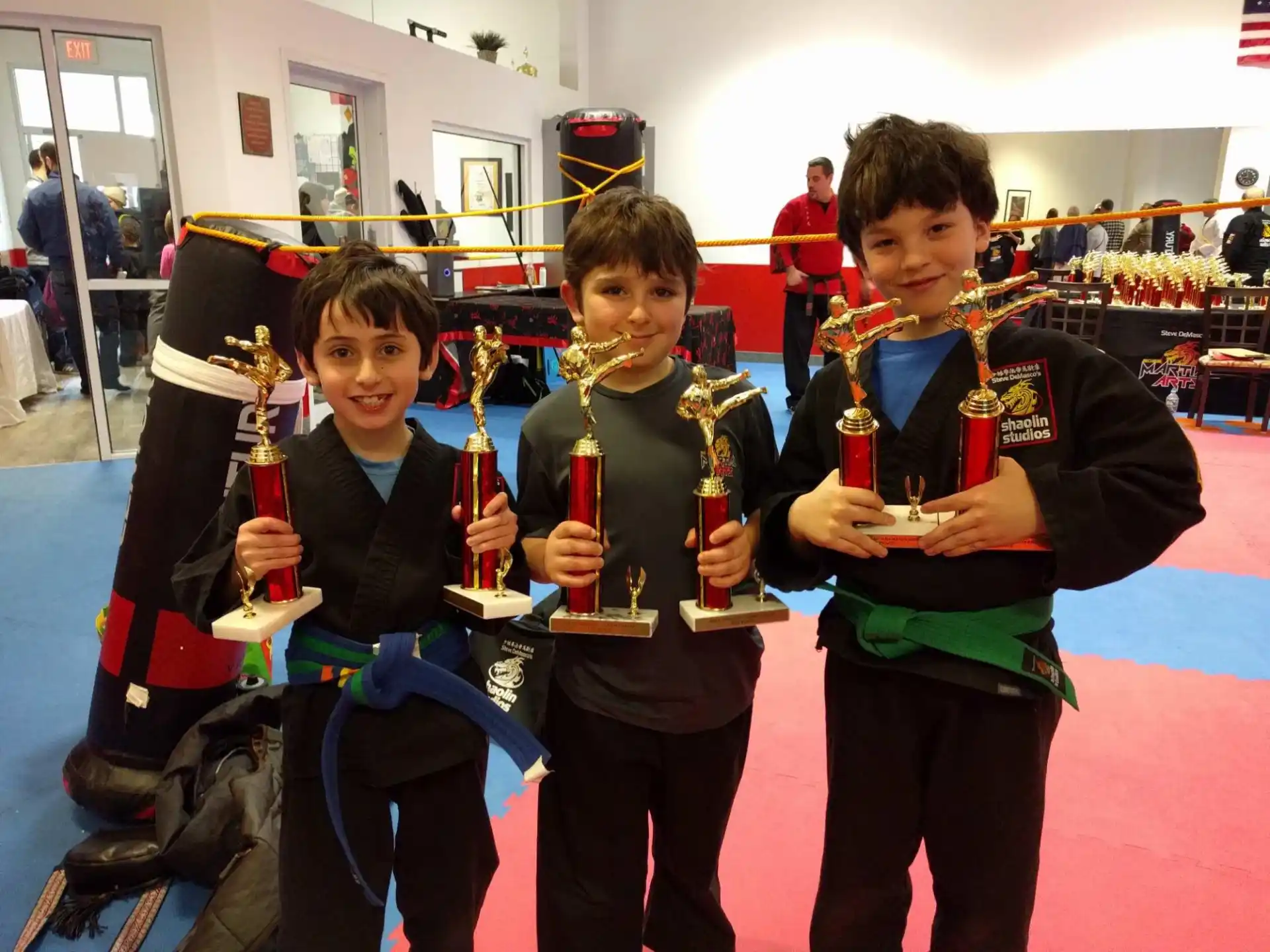 a group of boys holding trophies
