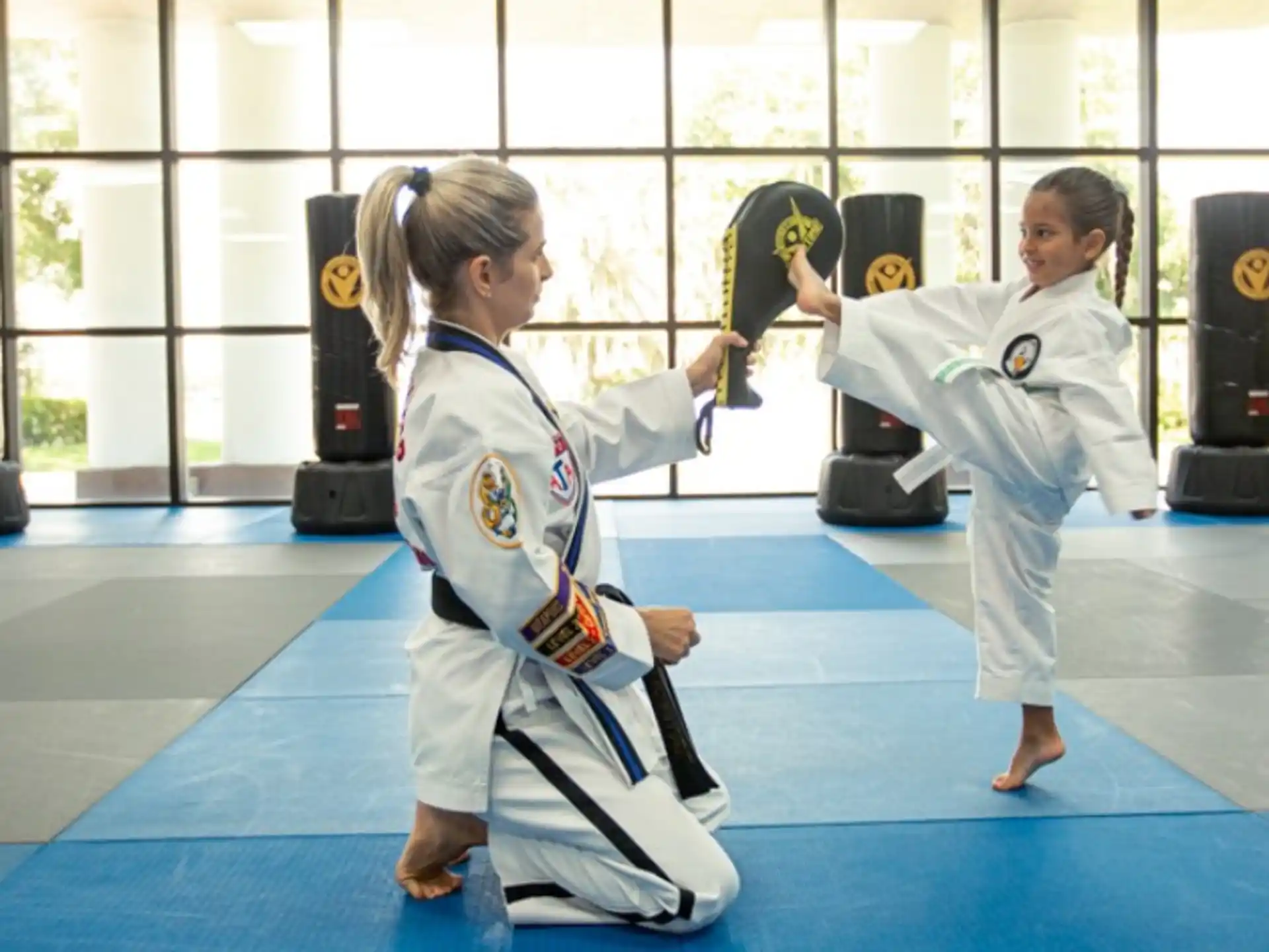 a couple of girls in karate uniforms
