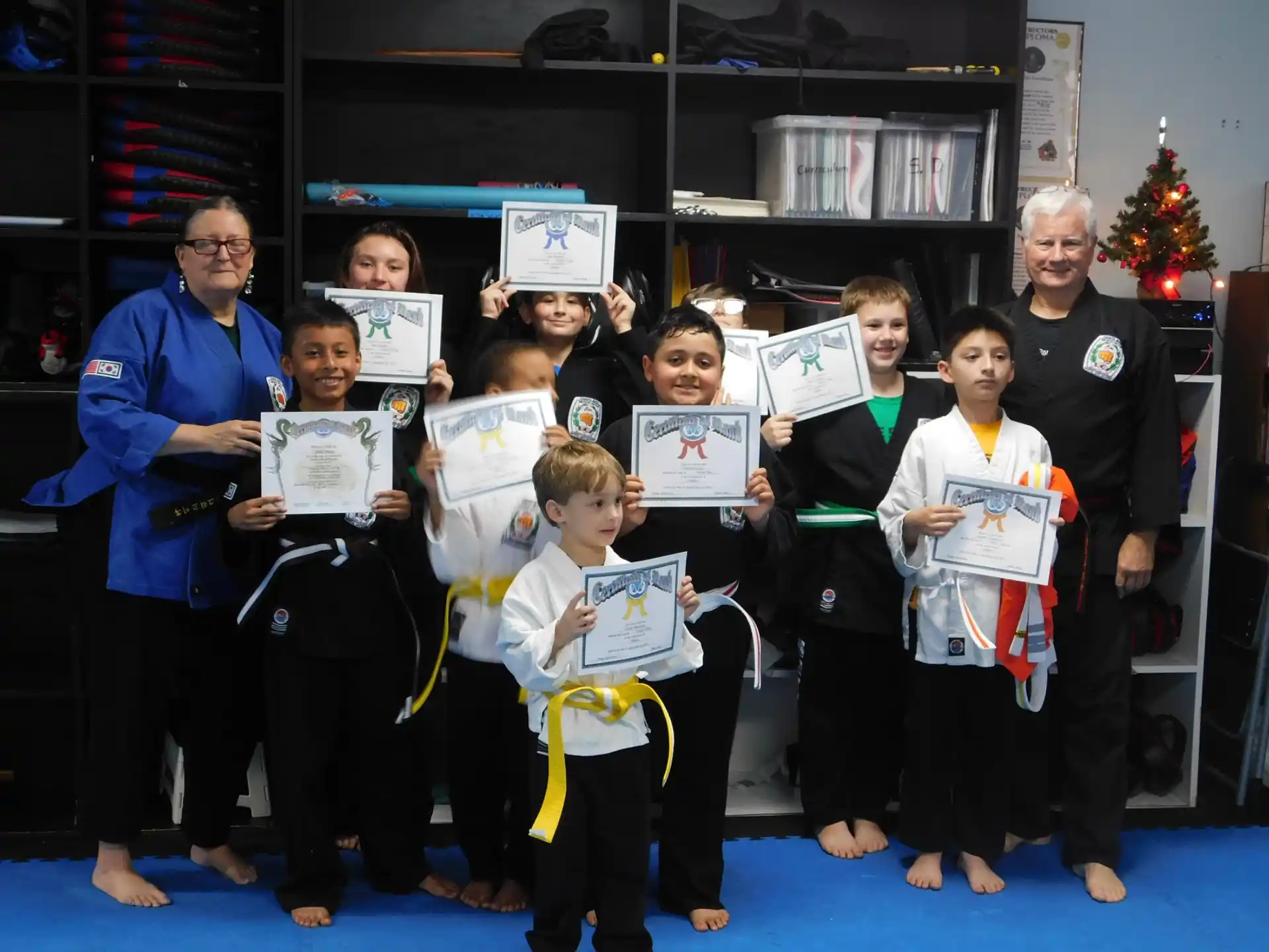 a group of people holding certificates