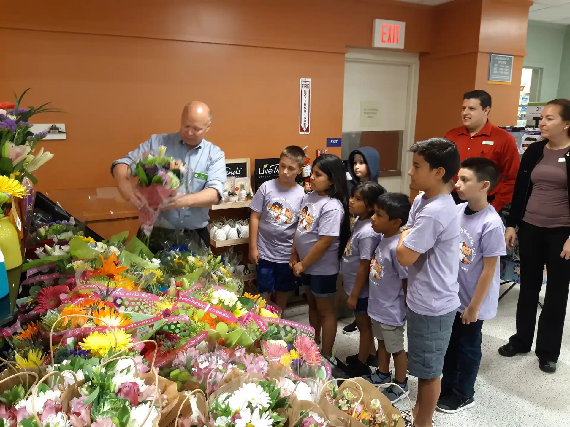 a group of people standing next to a person holding flowers