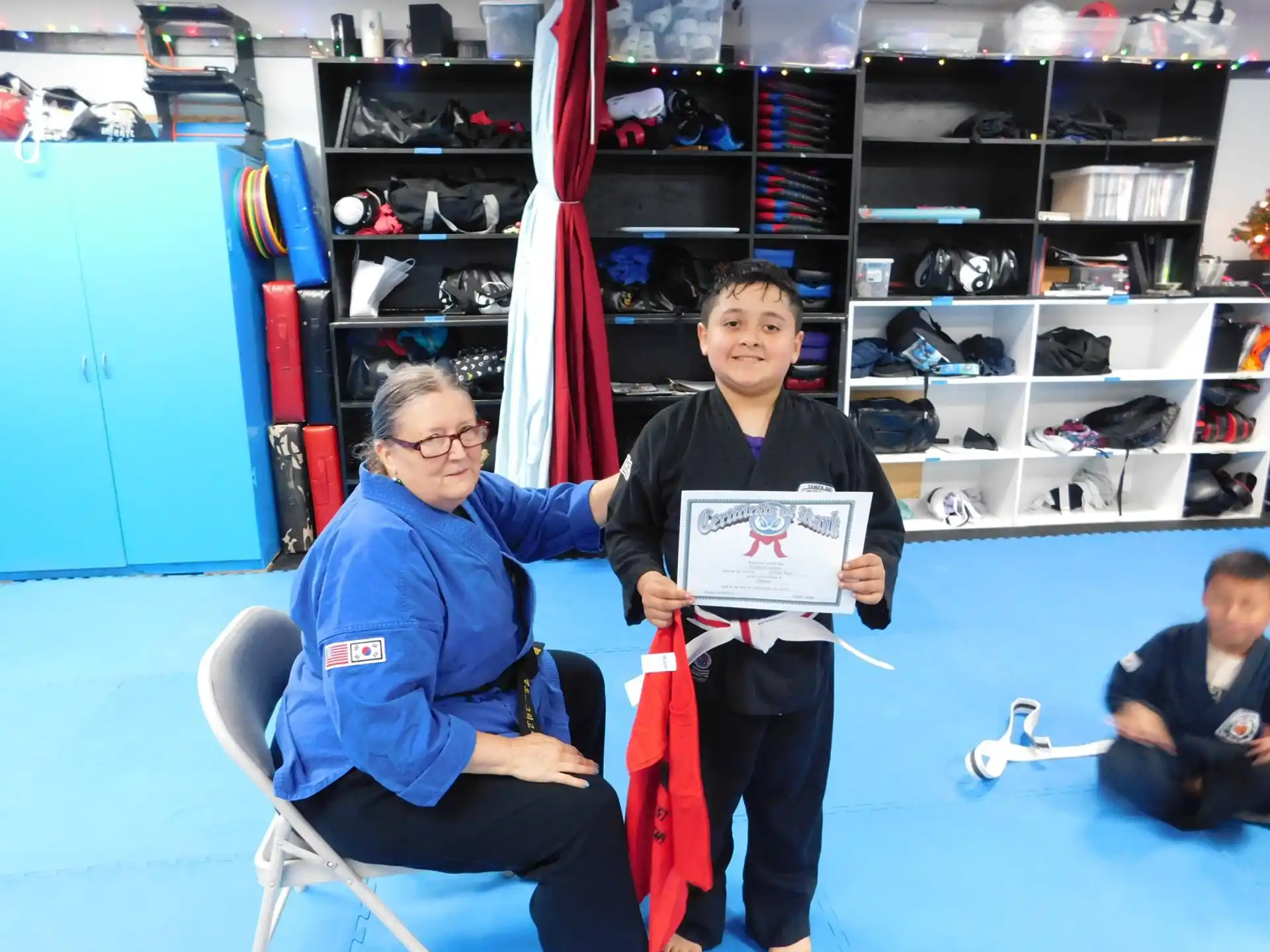 a person and a boy holding a sign