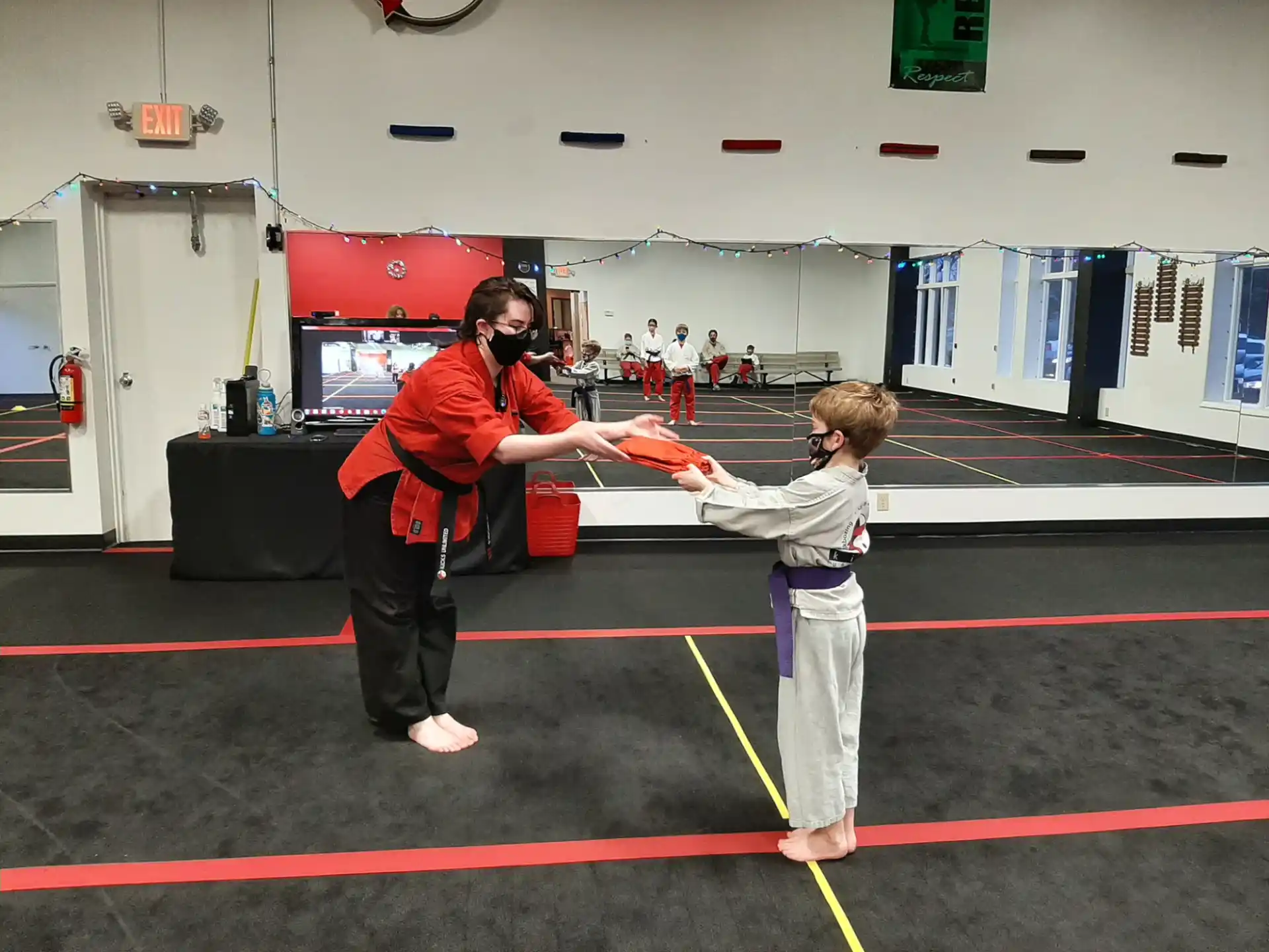 a person and a boy in a gym