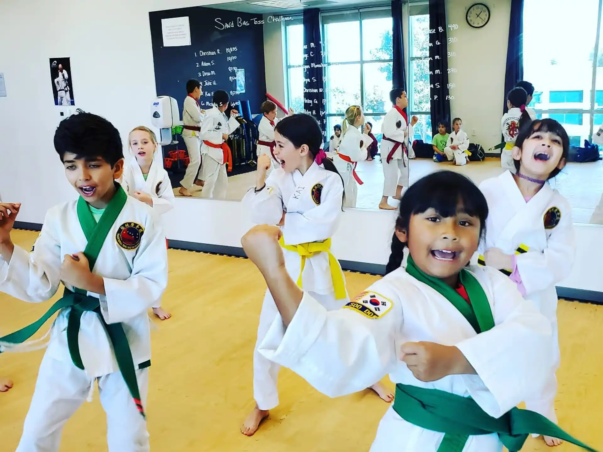 a group of children in karate uniforms