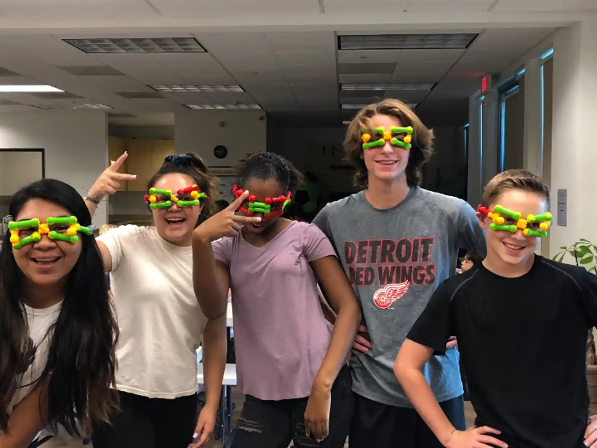 a group of people wearing colorful glasses