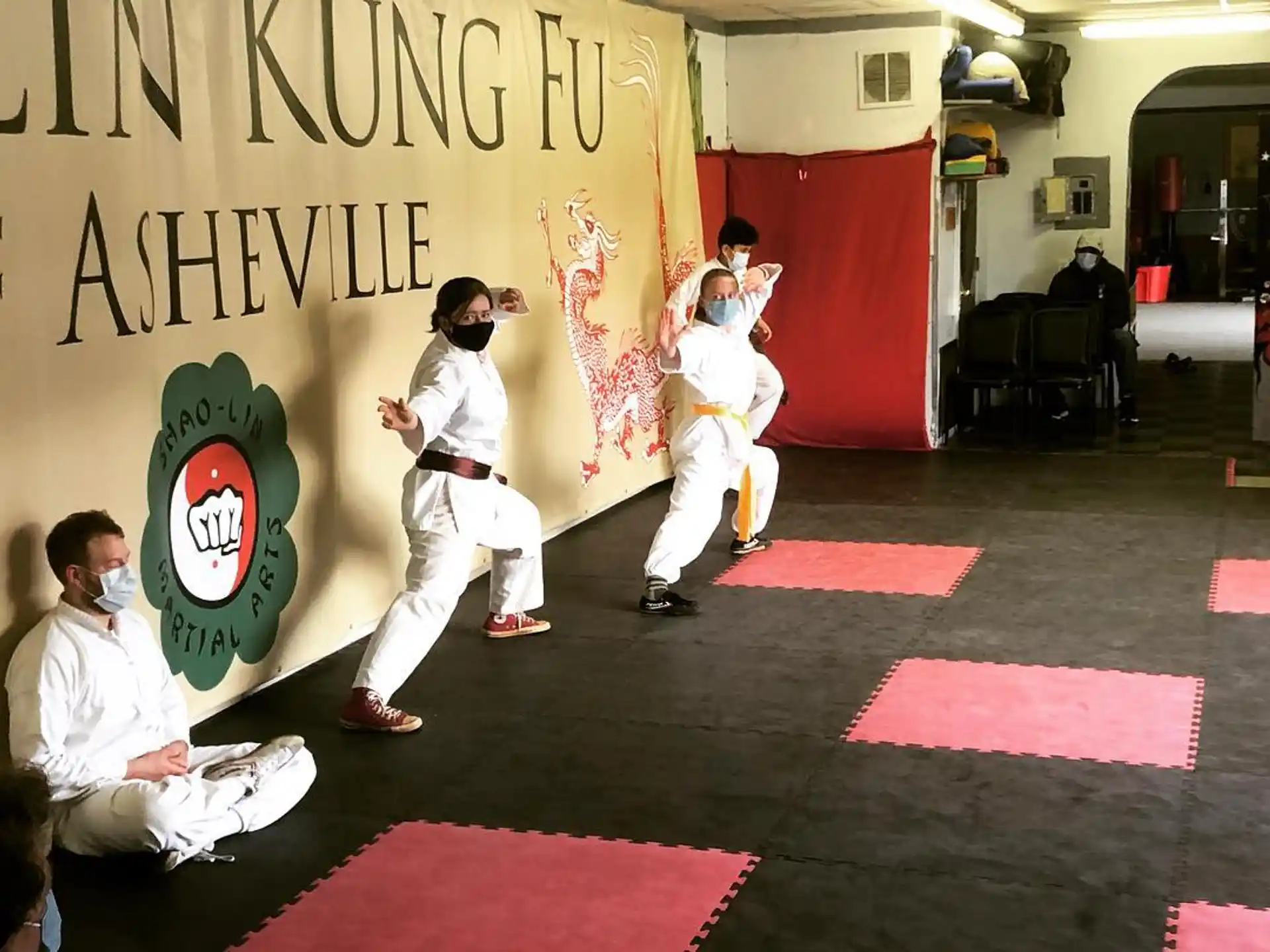 a group of people in karate uniforms