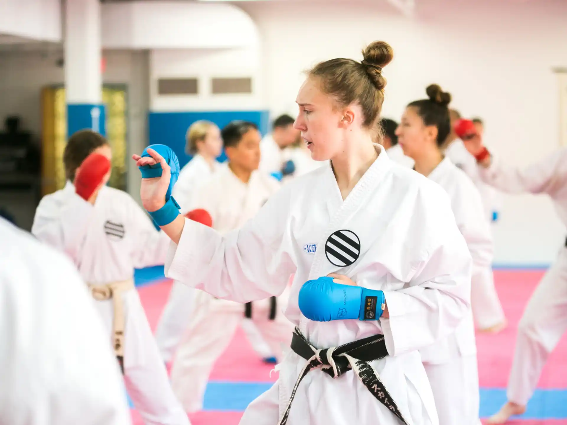 a group of people in white karate uniforms