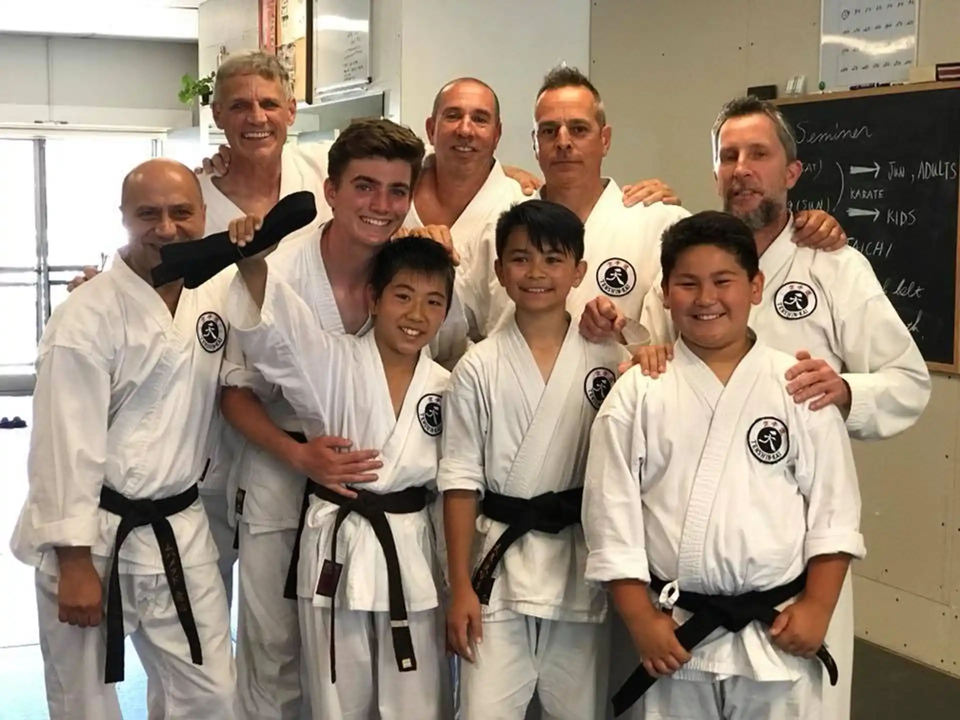 a group of people in karate uniforms