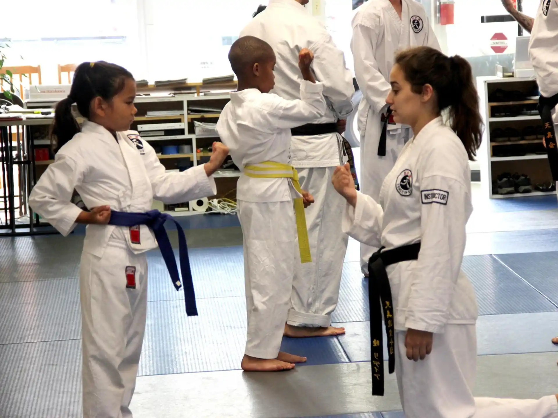 a group of people in white karate uniforms