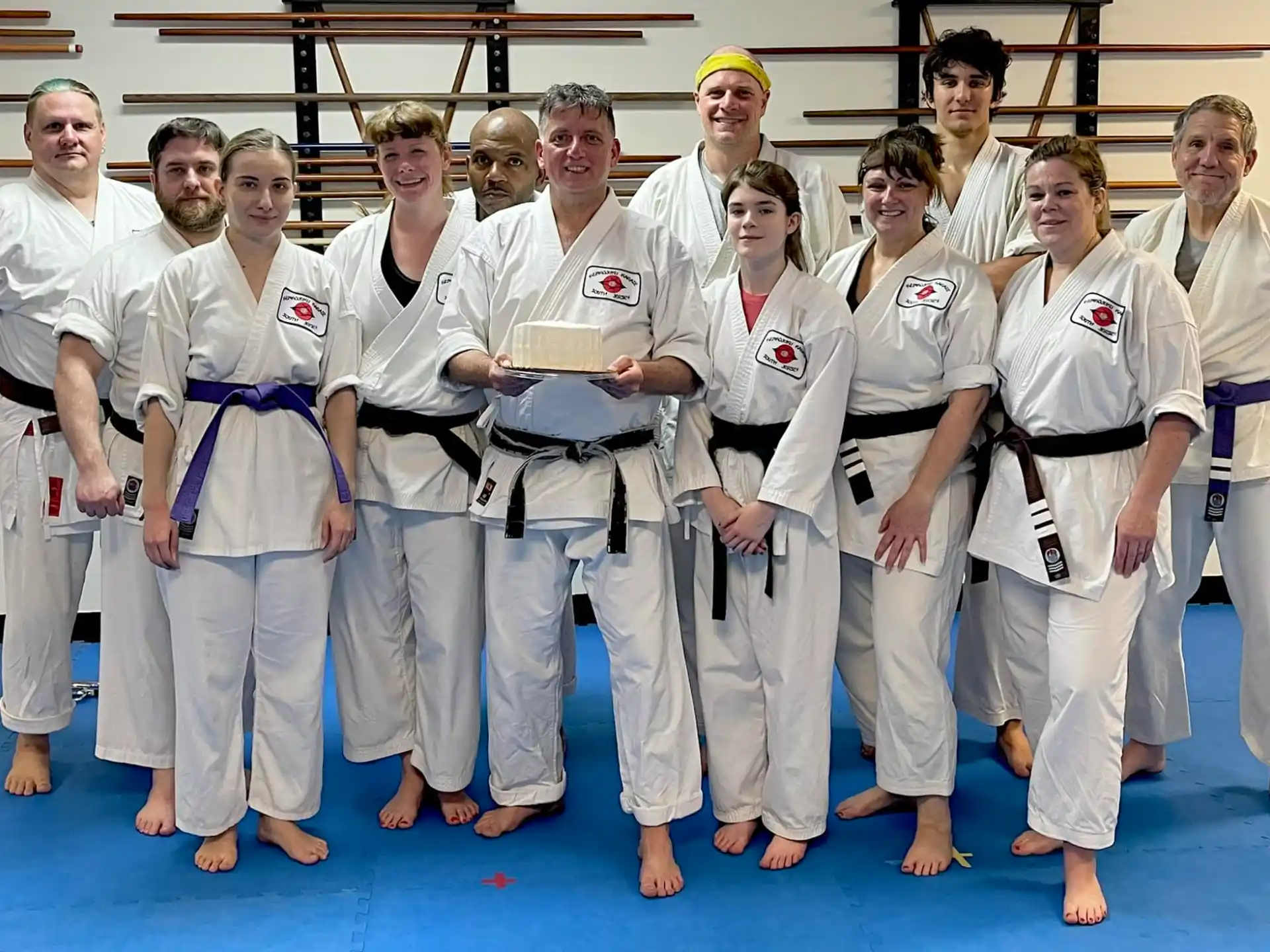 a group of people wearing white karate uniforms