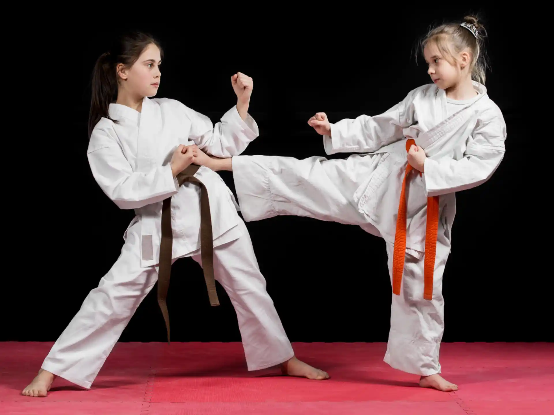 a group of girls in karate uniforms