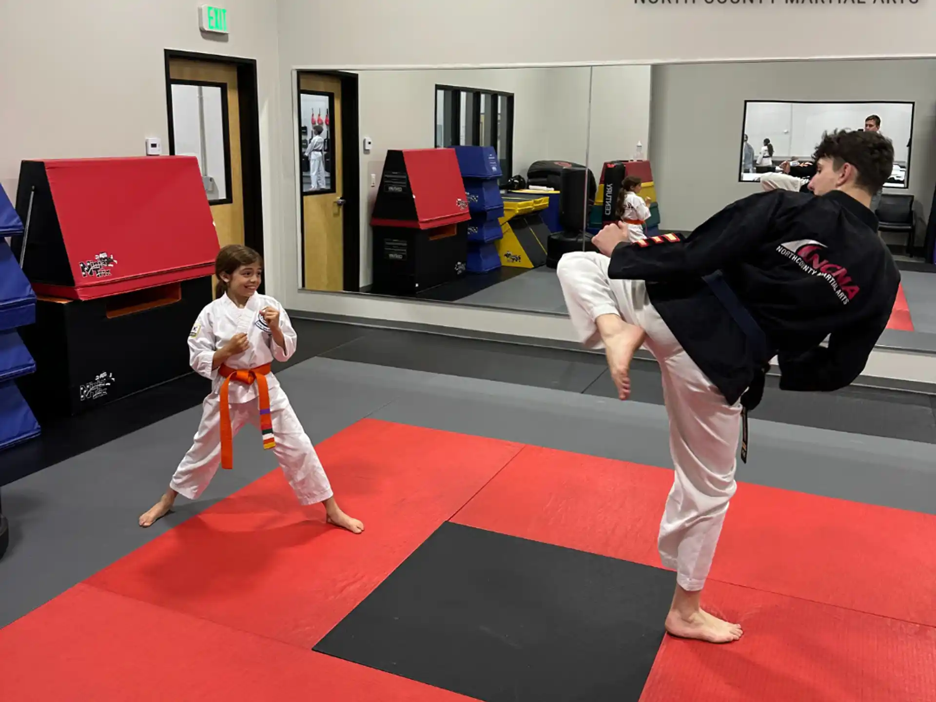 a person and a boy practicing karate