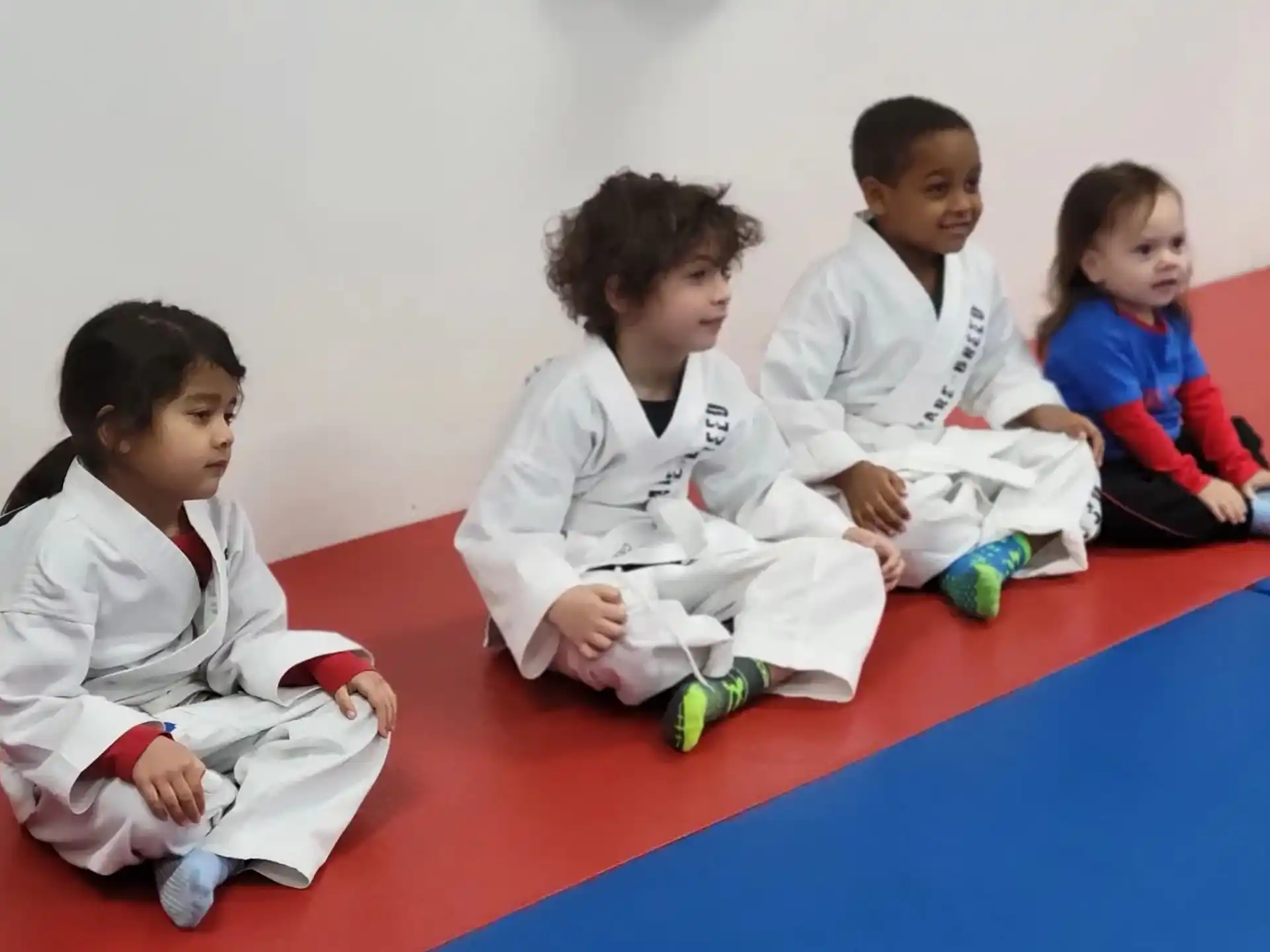 a group of children in white uniforms