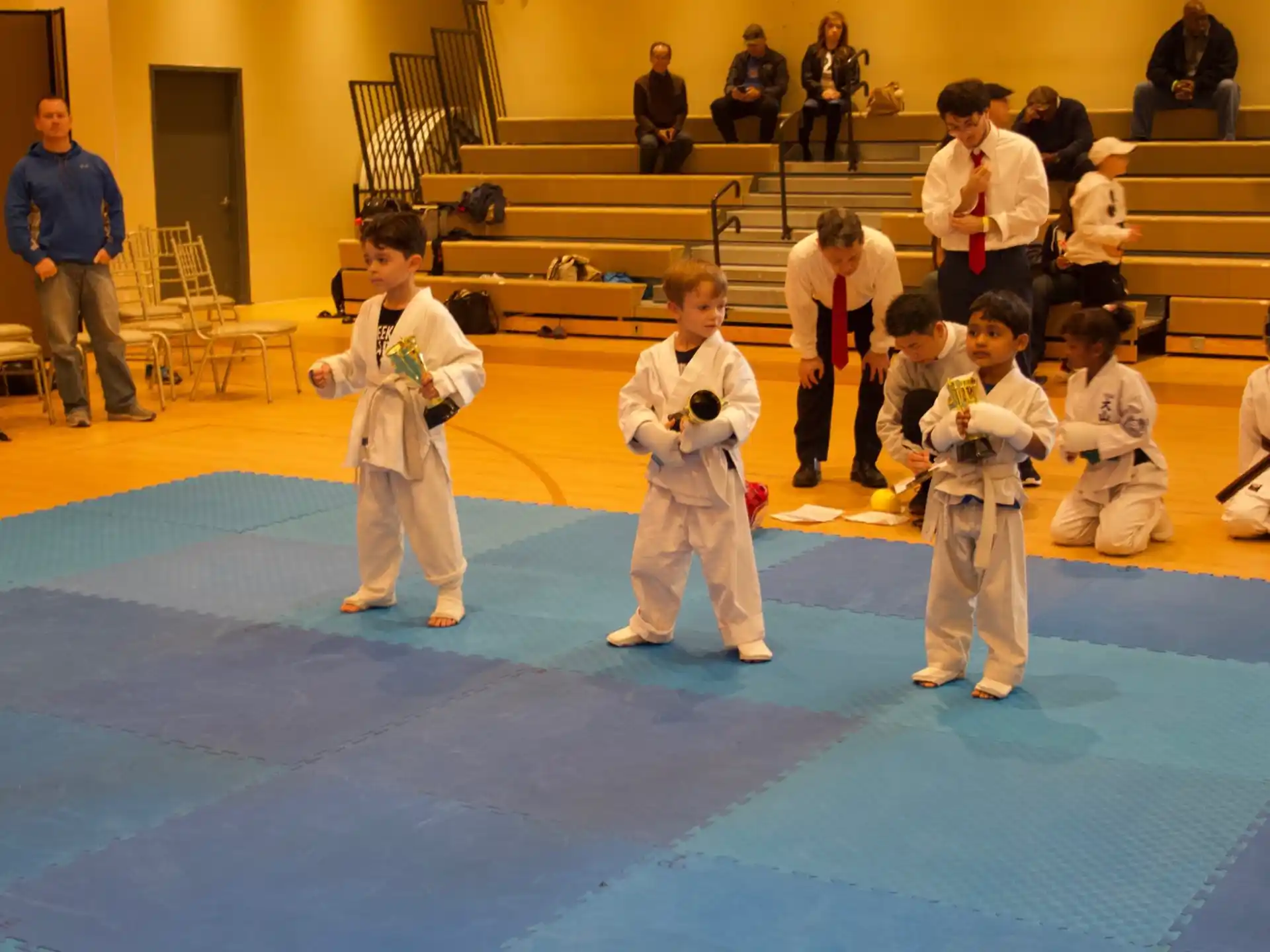 a group of children in karate uniforms