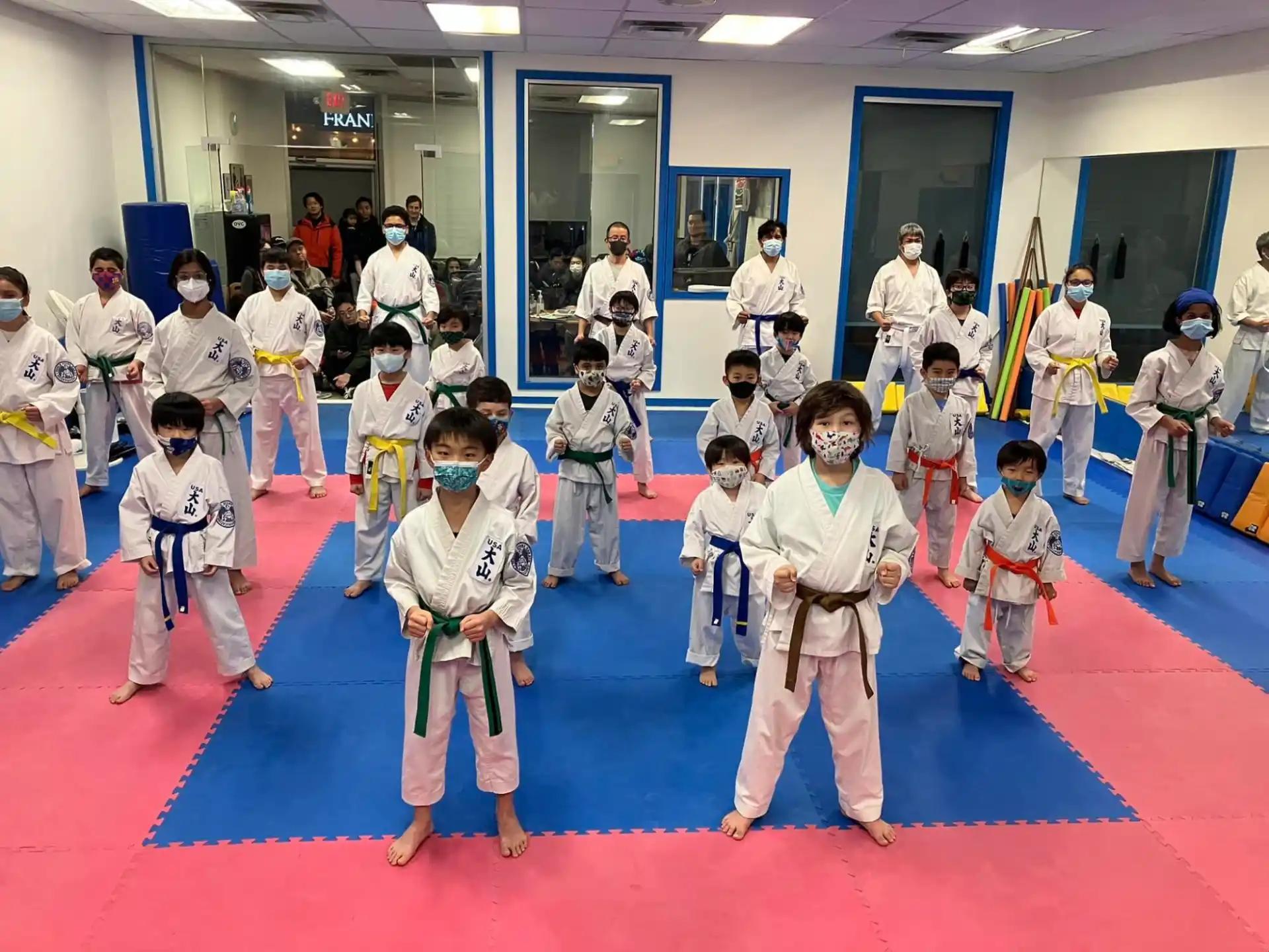 a group of children in karate uniforms