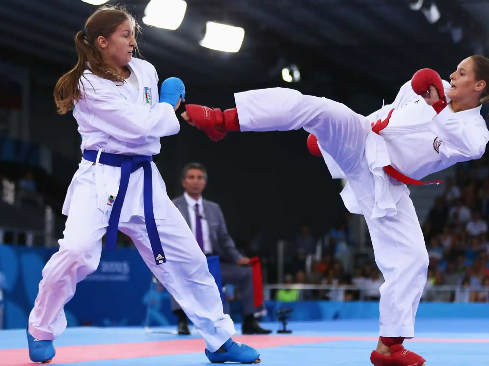 a couple of women in karate uniforms