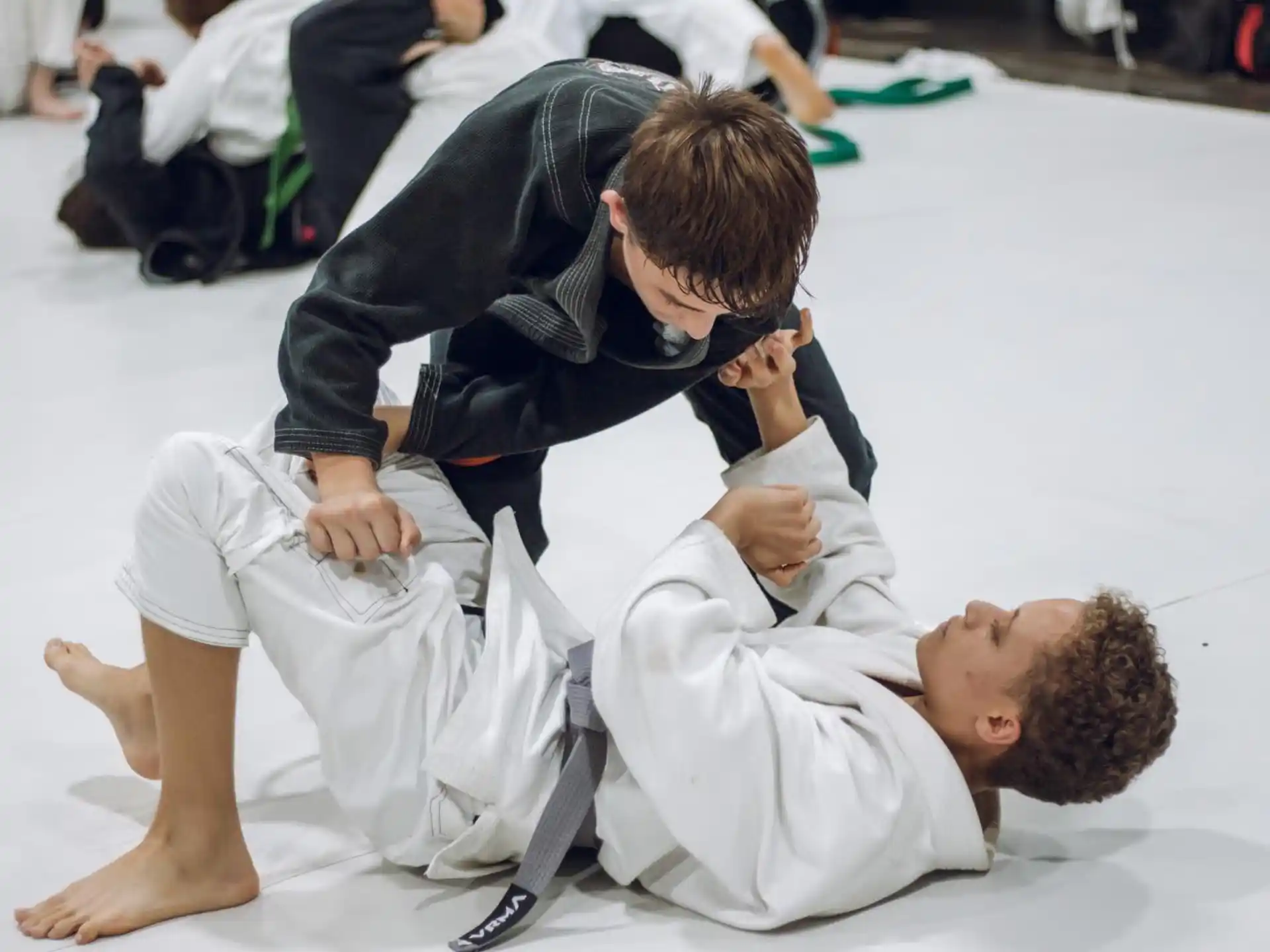 a man in a karate uniform with another man in a white shirt