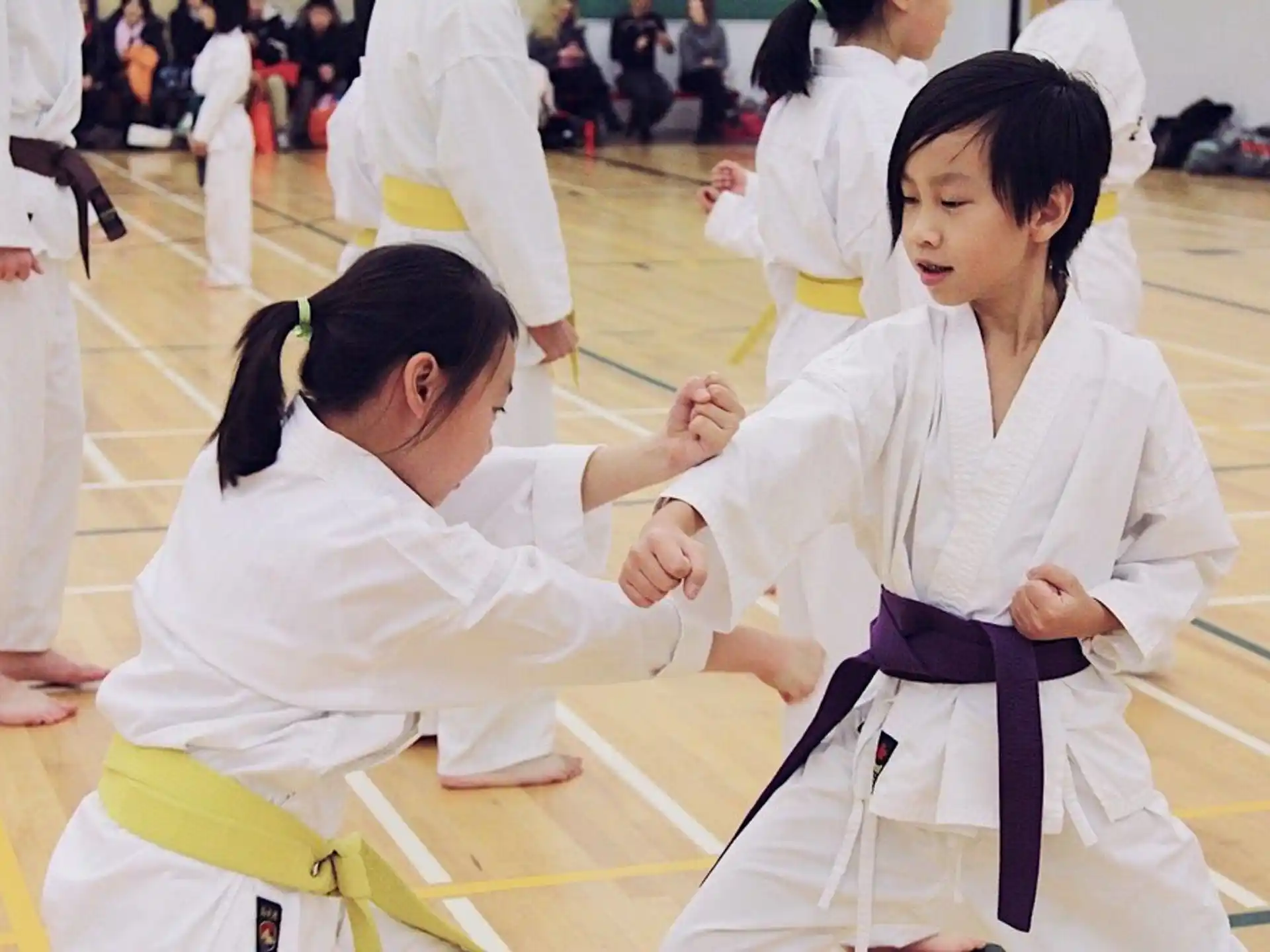 a group of girls in karate uniforms