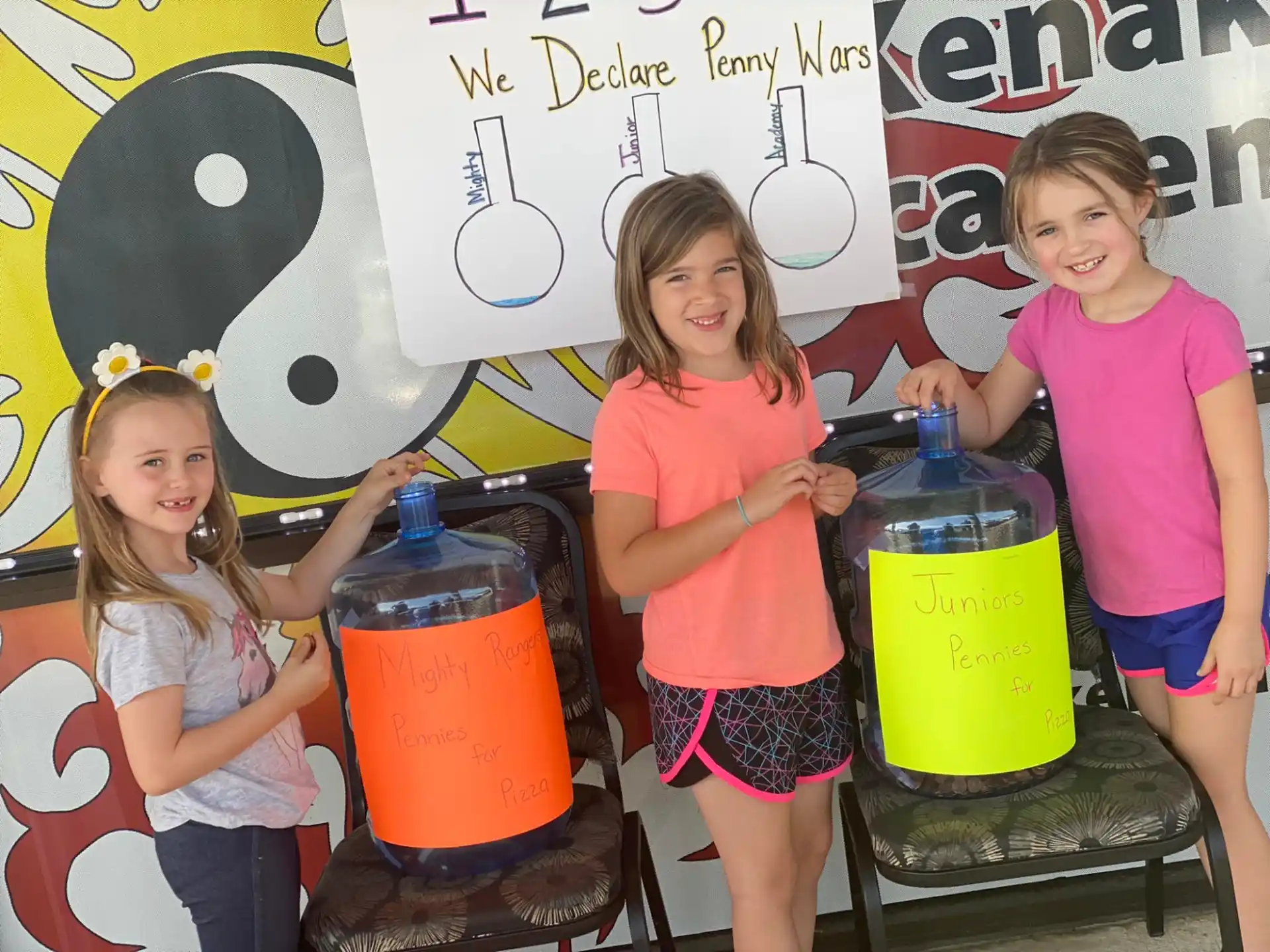 a group of girls holding buckets