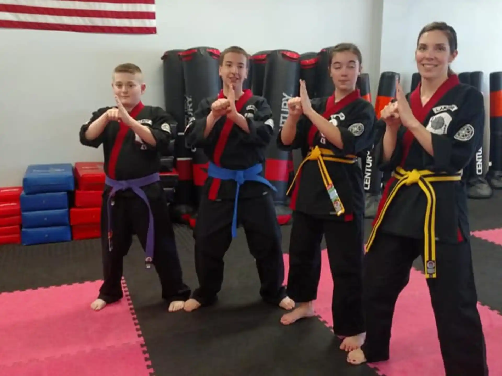a group of people in martial arts uniforms posing for a photo