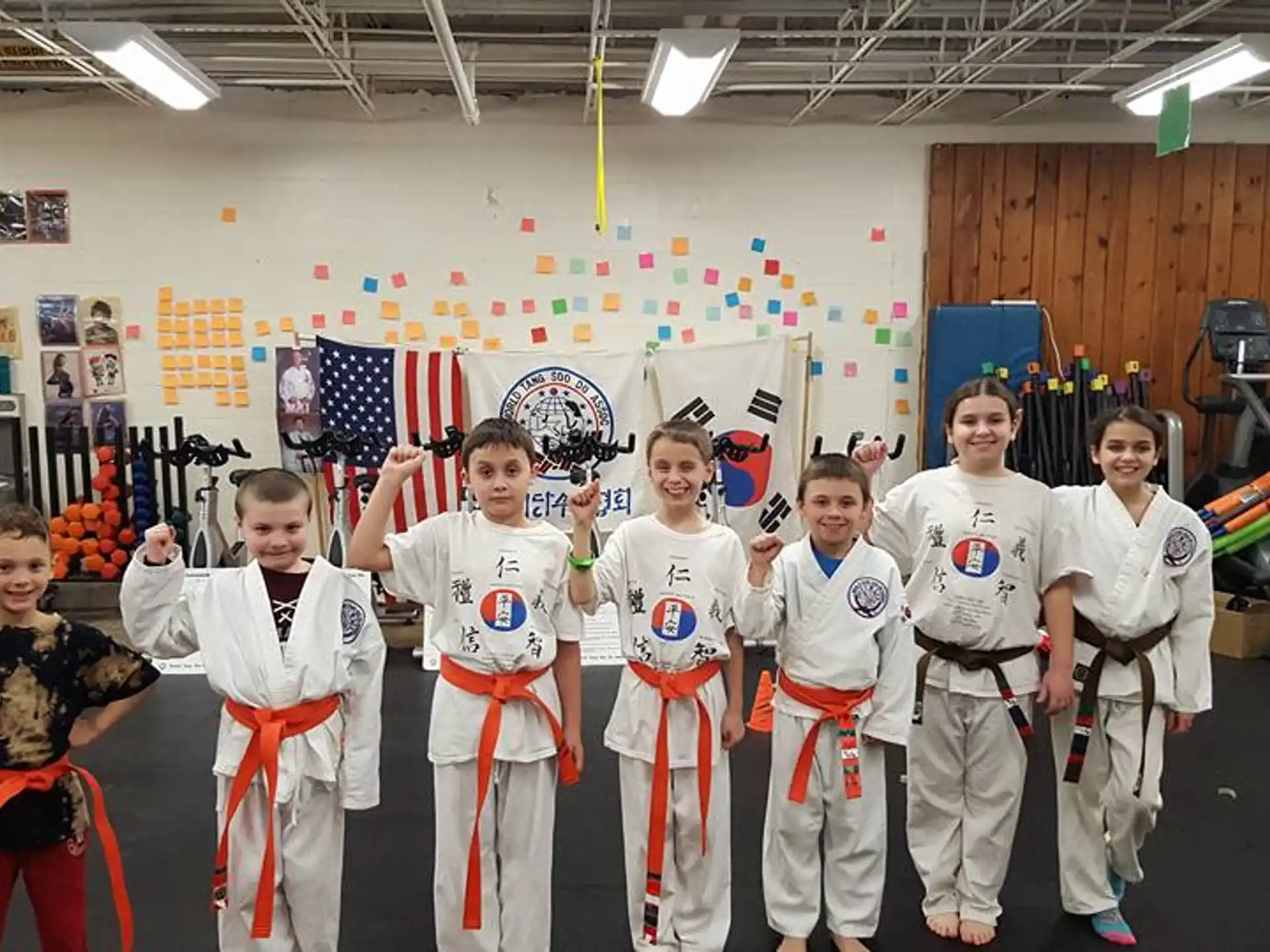 a group of kids in karate uniforms