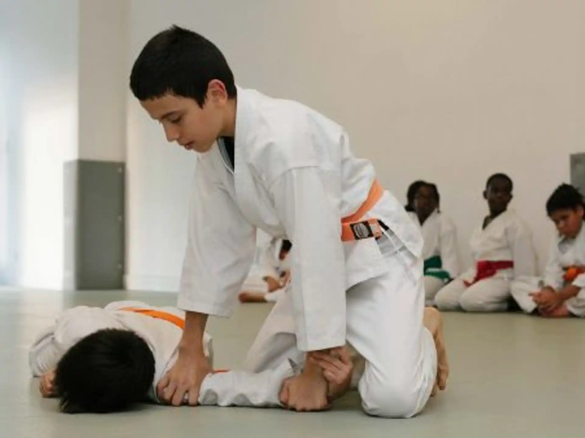 a man kneeling down to touch a boy's head