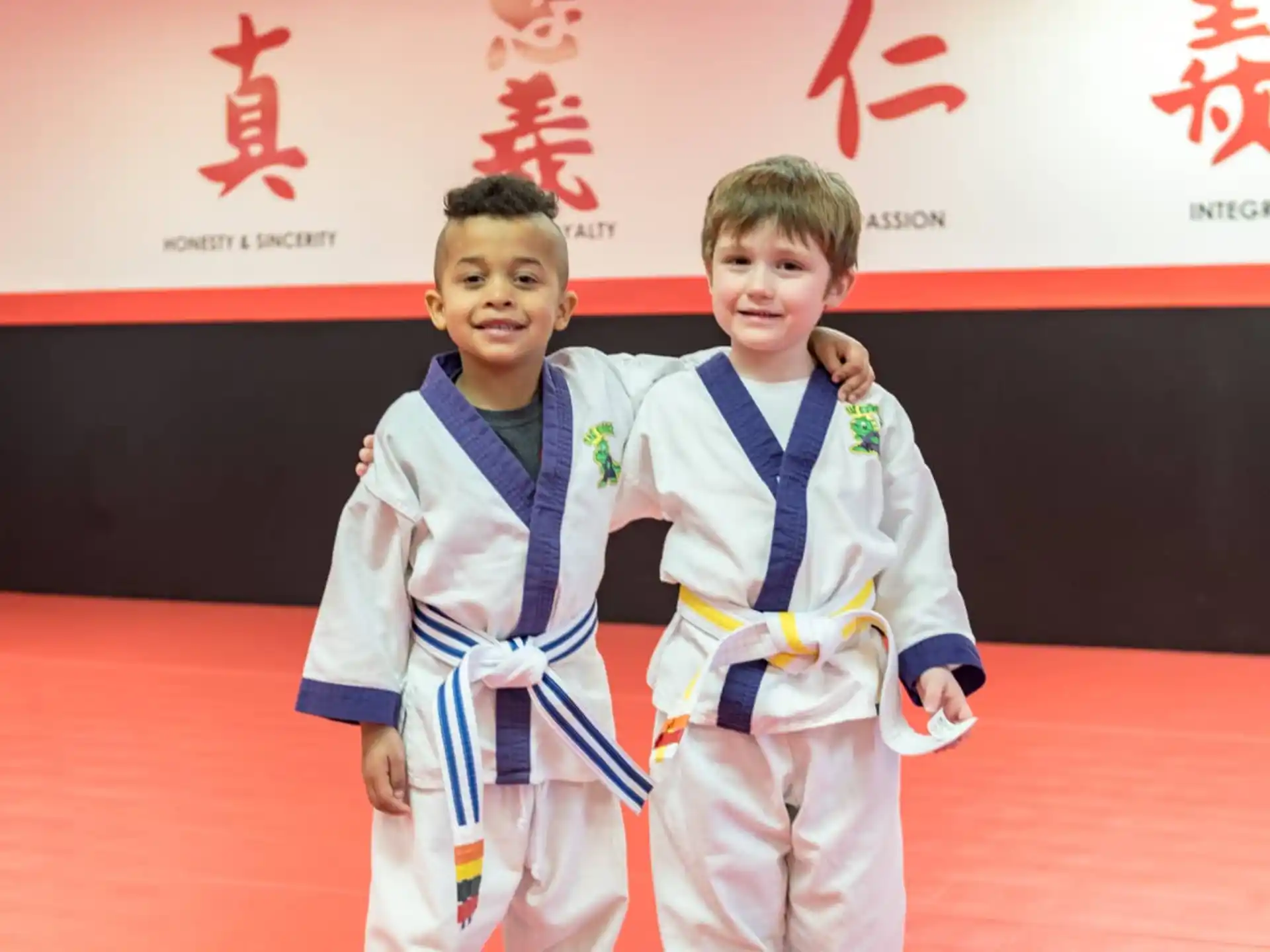 a couple of boys wearing medals