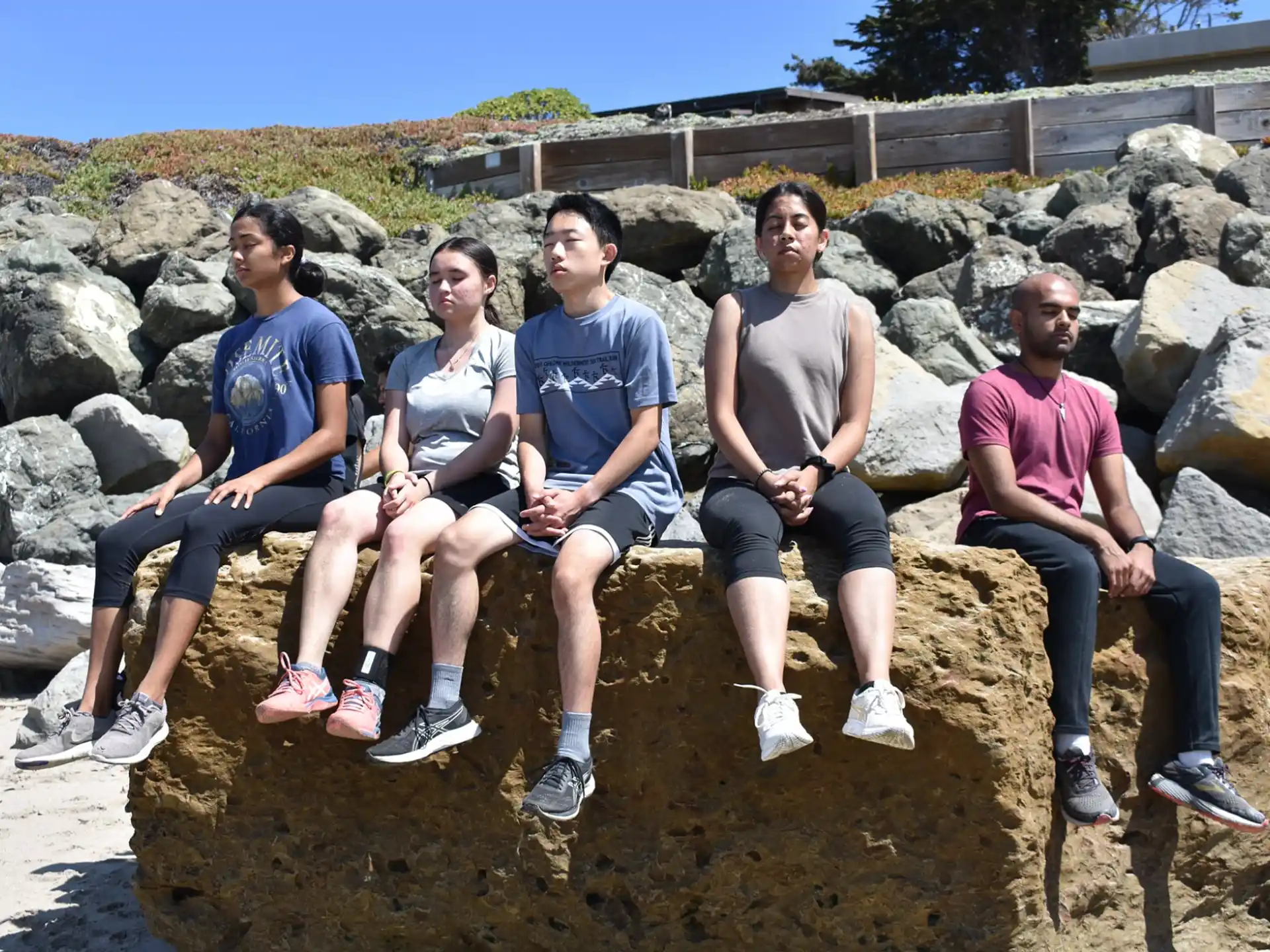 a group of people sitting on rocks
