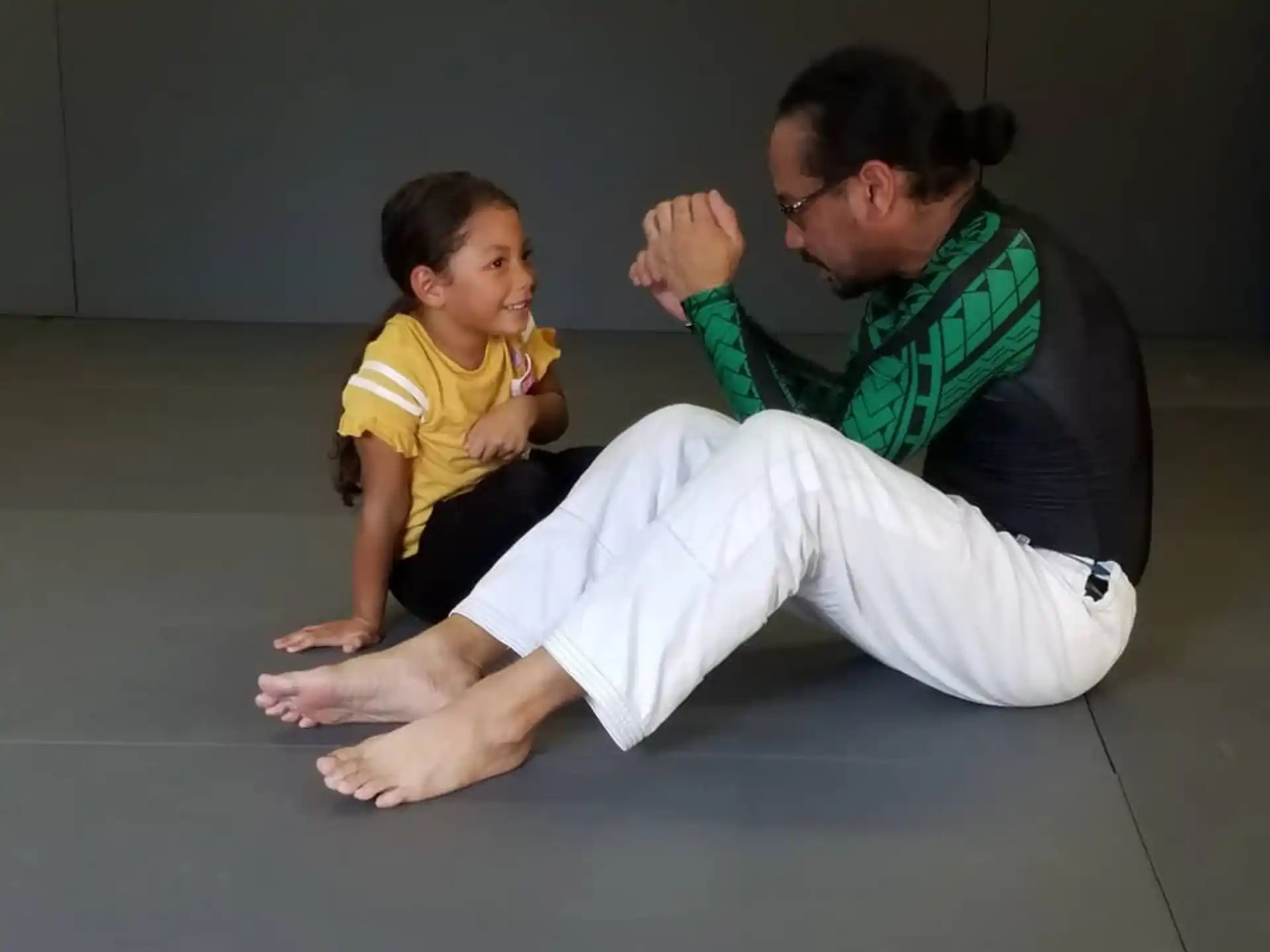 a man and a boy sitting on the floor