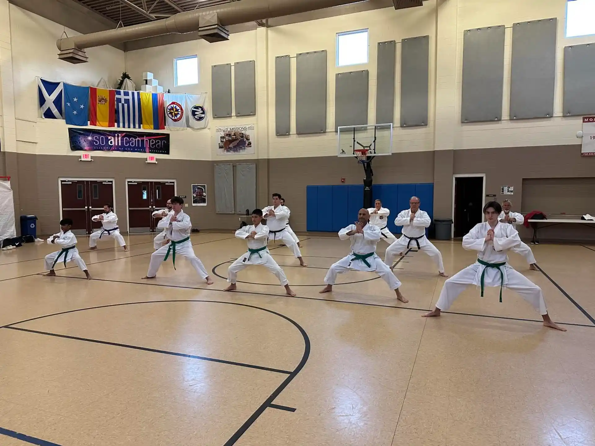 a group of people in white uniforms in a gym