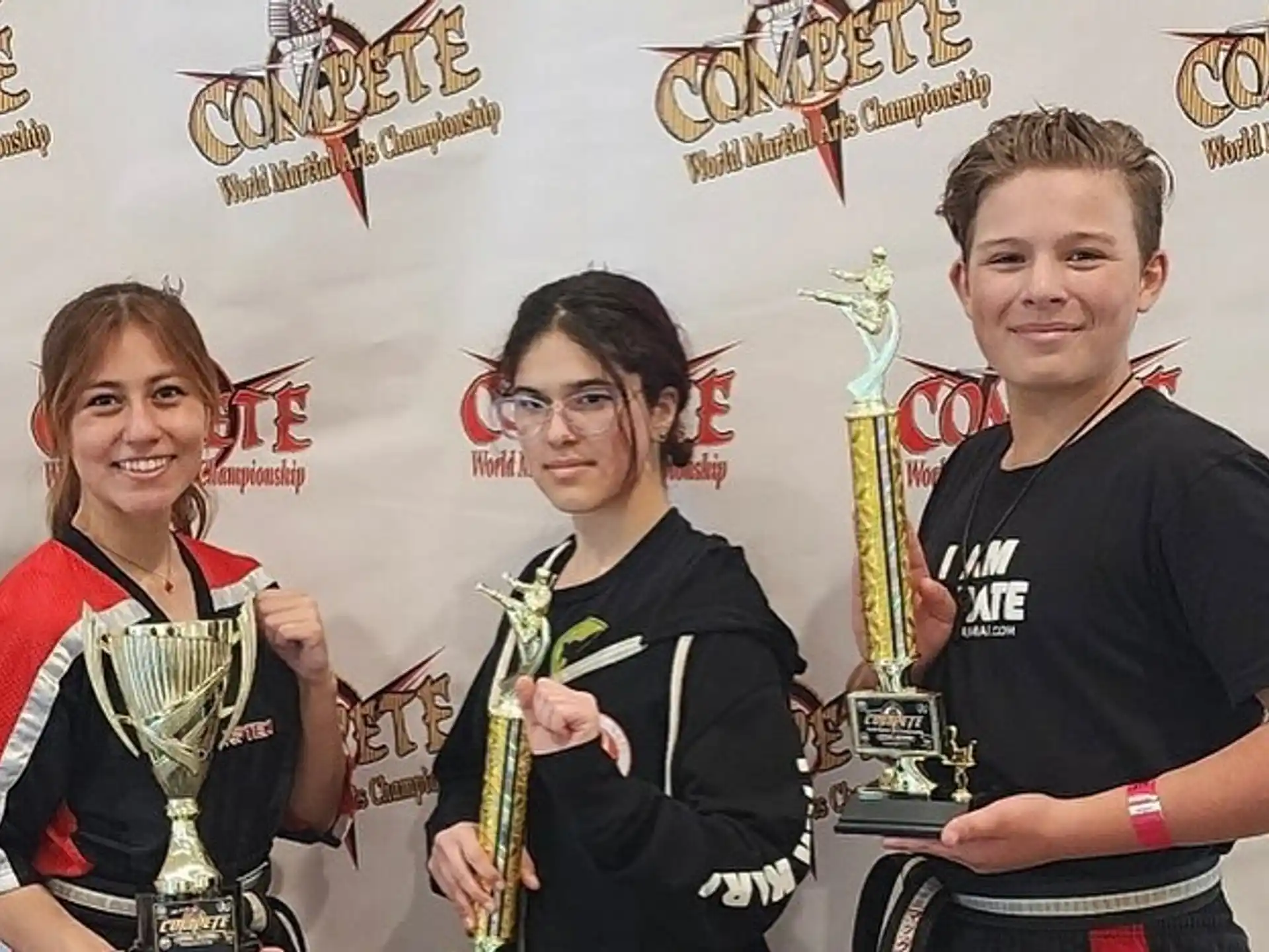 a group of people holding trophies