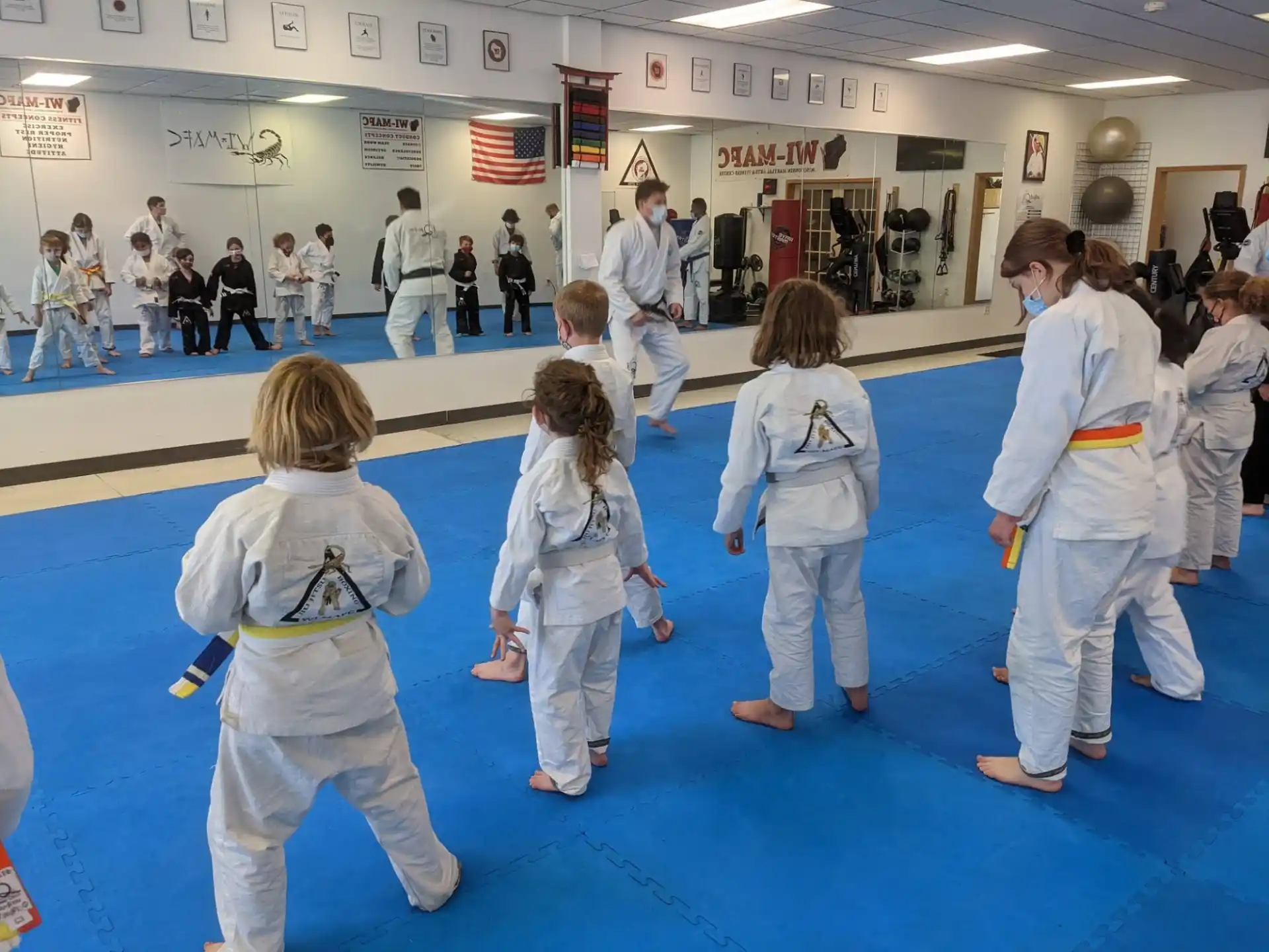 a group of children in karate uniforms