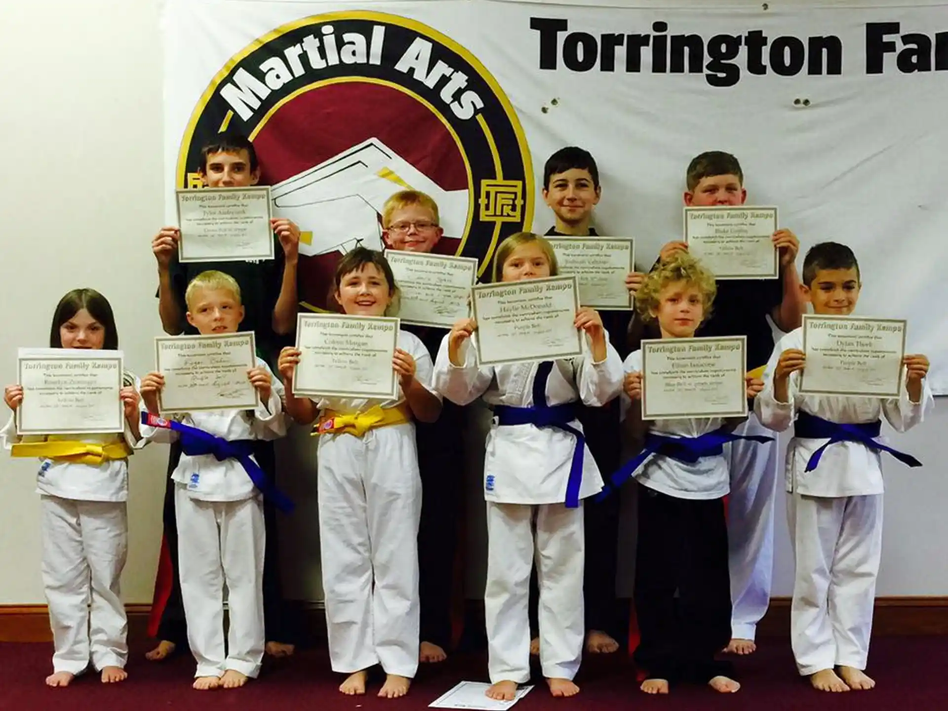 a group of children holding certificates