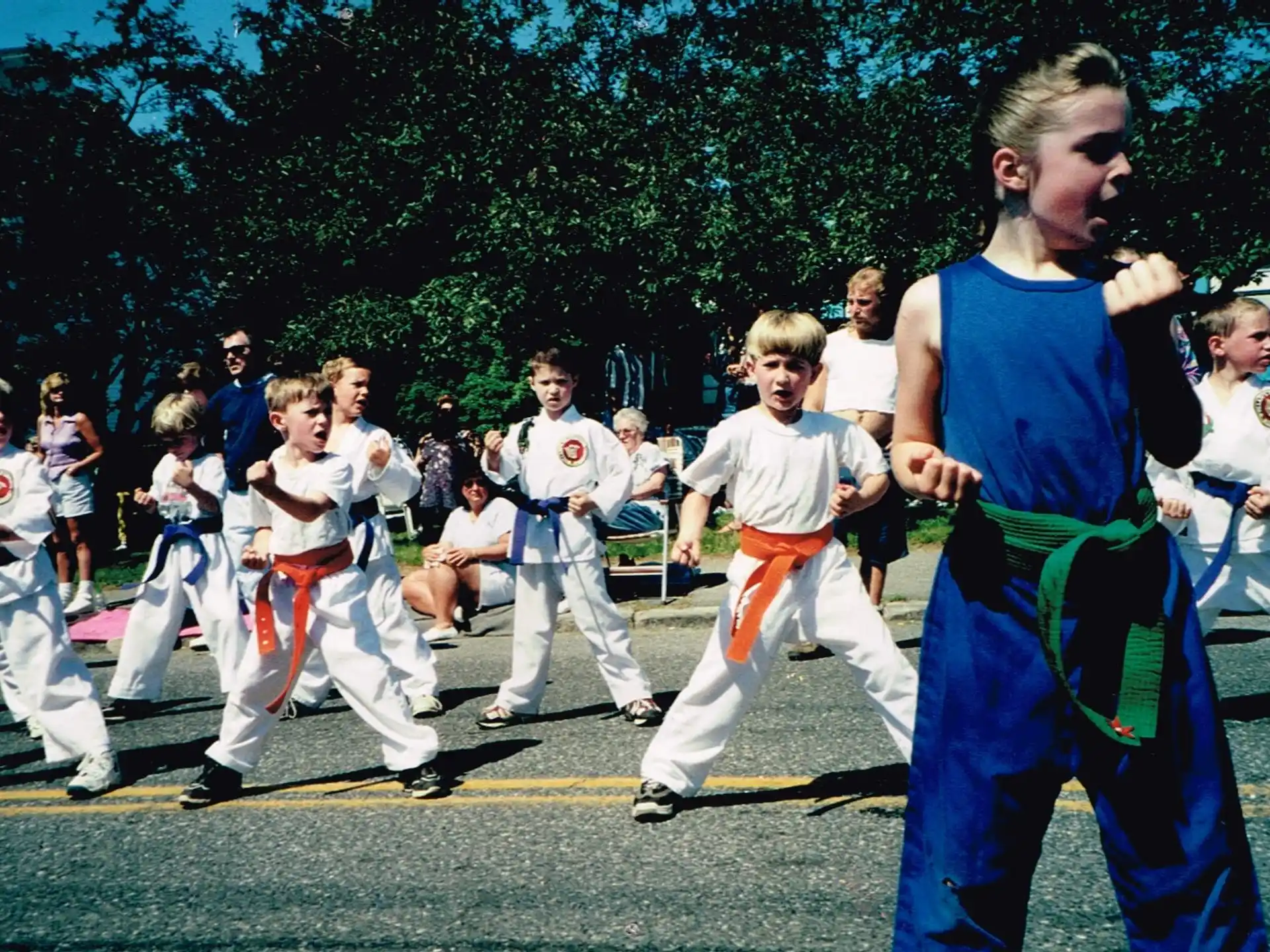 a group of children in karate uniforms