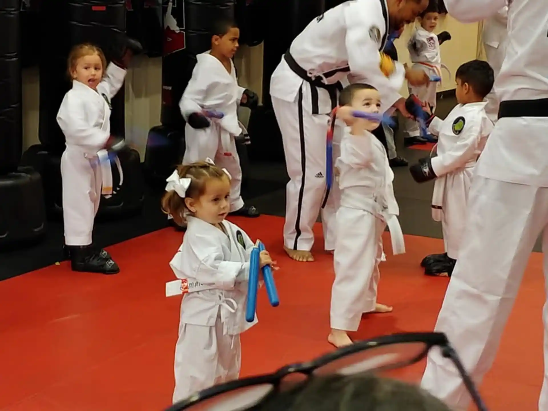 a group of children in karate uniforms