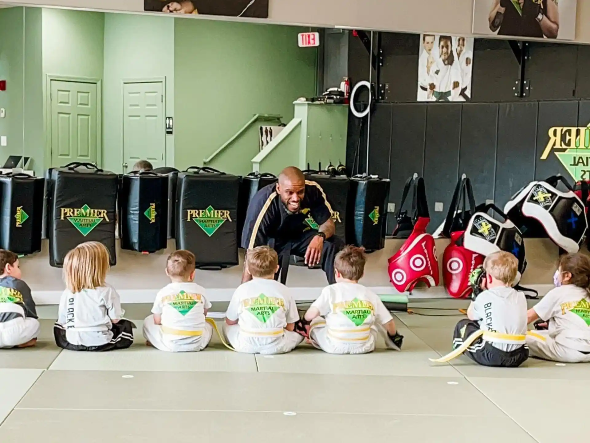 a group of children sitting on the floor in a room