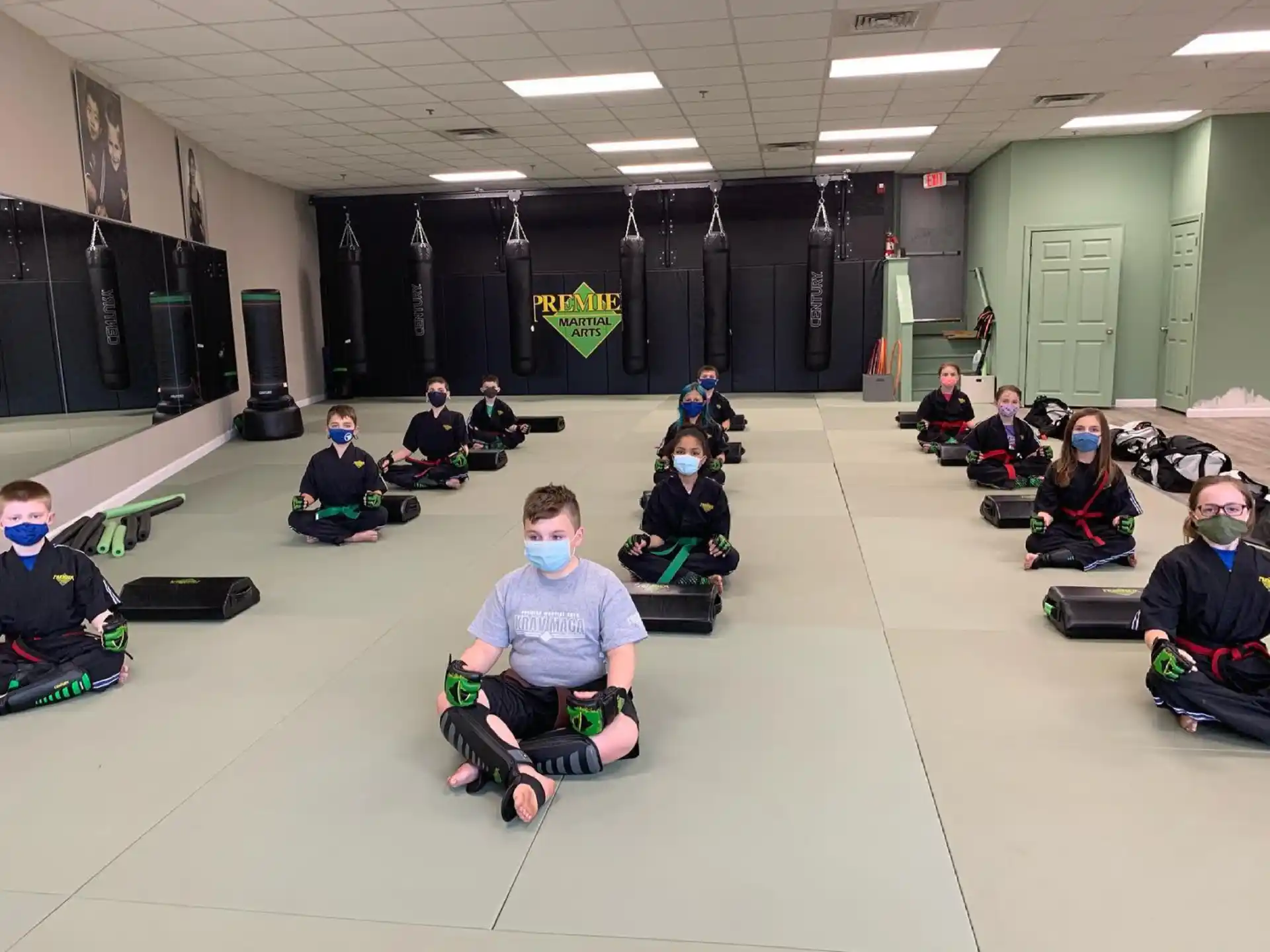 a group of people sitting on the floor with their heads in their hands