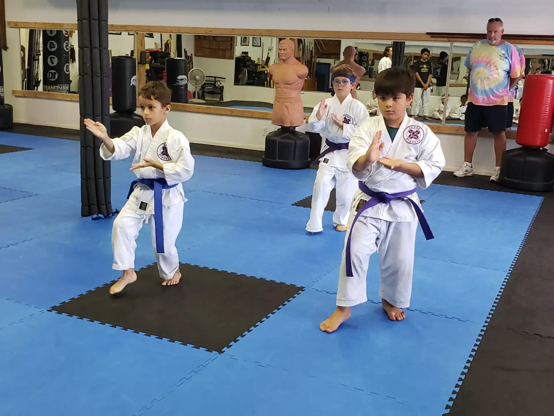 a group of kids in karate uniforms