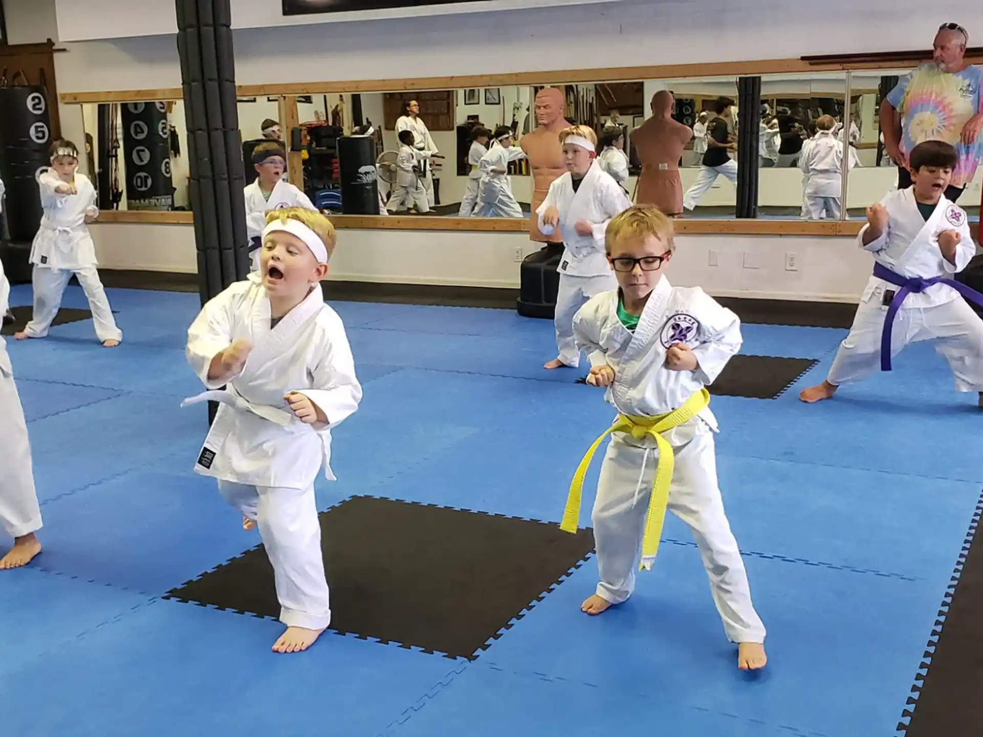 a group of people in karate uniforms