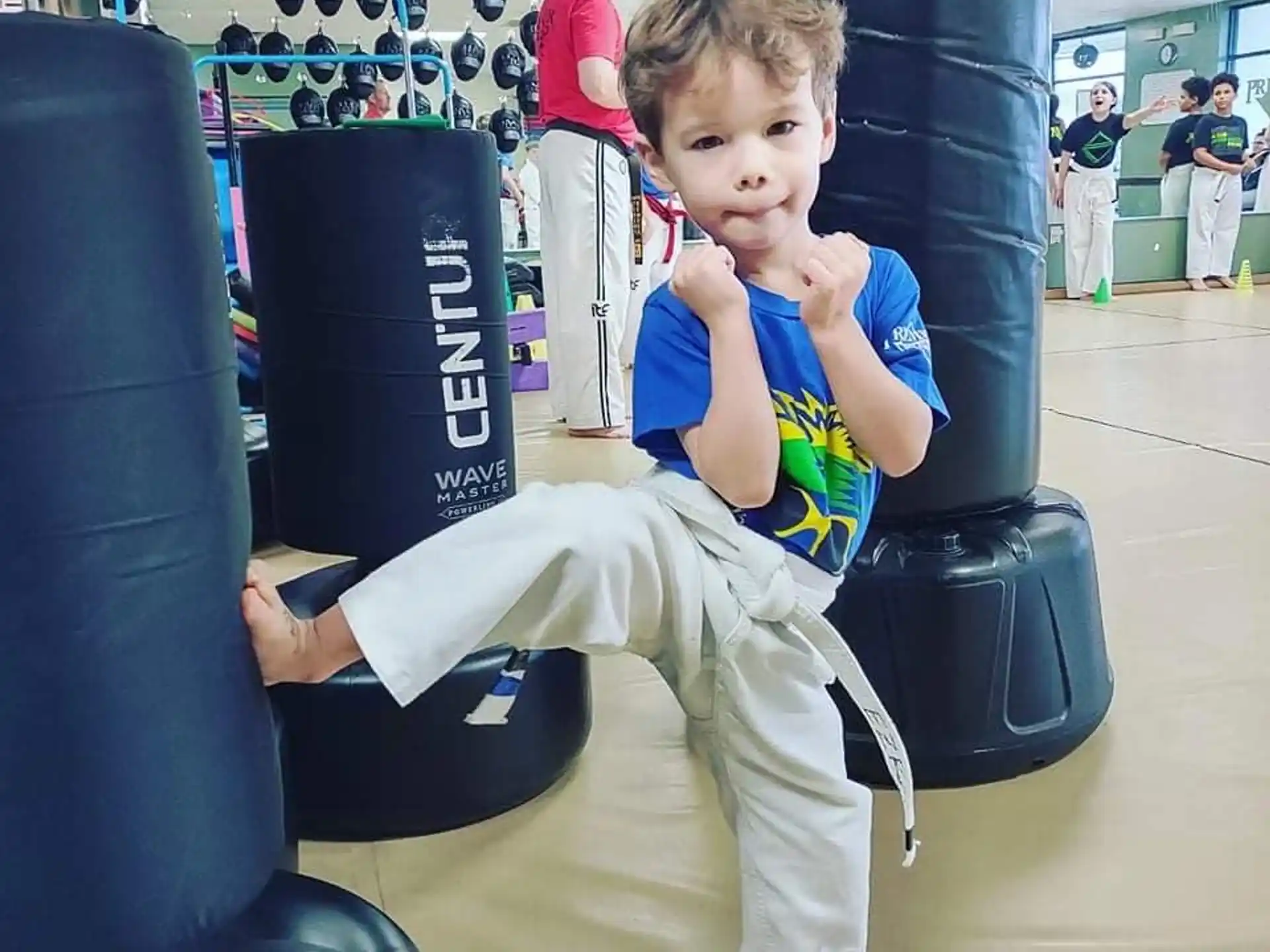a boy sitting on a gym chair