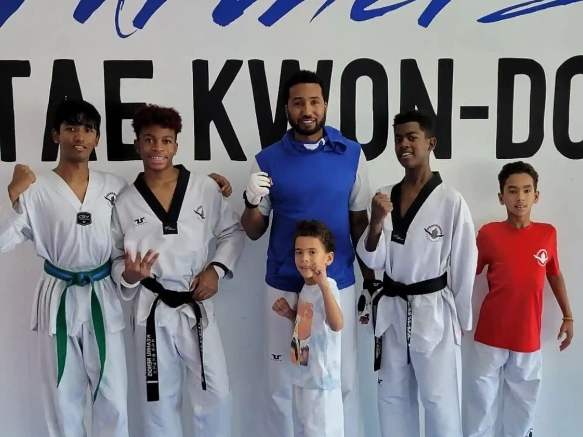 a group of people in white karate uniforms